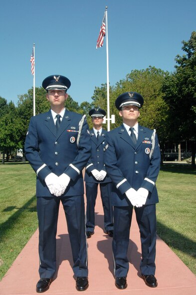 OFFUTT AIR FORCE BASE, Neb.- Honor Guard members Airman 1st Class Jeffery Hunsberger, from the 1st Aircraft Maintenence Unit, Staff Sgt. Gene Pabst, non-commissioned officer in charge of the Honor Guard detail from the 97th Intelligence Squadron, and Airman 1st Class Raymond Elizalde, from the 55th Maintanence Squadron, stand at ceremonial parade rest just before the retreat ceremony signaling the end of the duty day at the Offutt Parade Grounds Aug 6. US Air Force photo by D.P. Heard