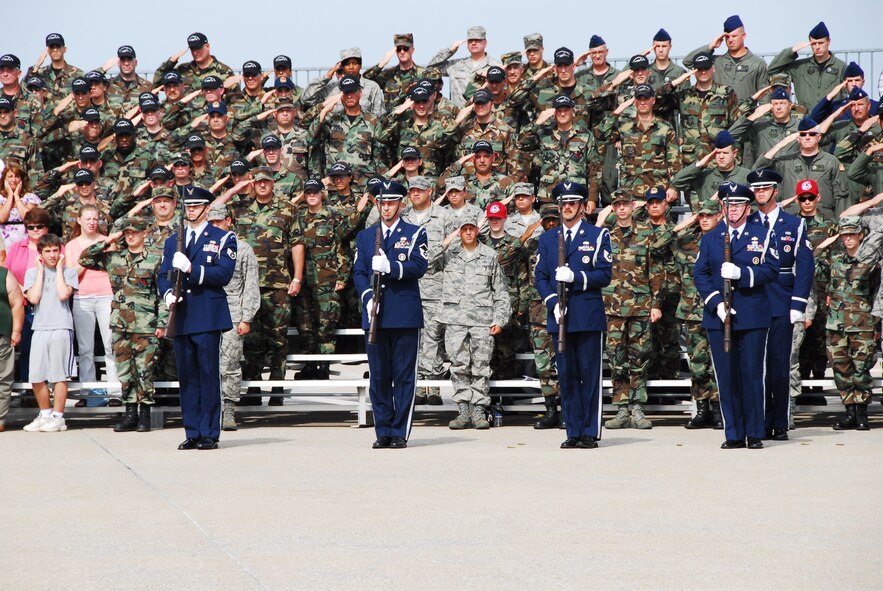 Airmen and their families stand at attention and salute with the color guard while the National Anthem plays during the Flight of Freedom ceremony held at the 193rd Special Operations Wing, Middletown, Pa. on Sept.14, 2008. Air Force photo by Staff Sgt. Mariko Rauch (released).