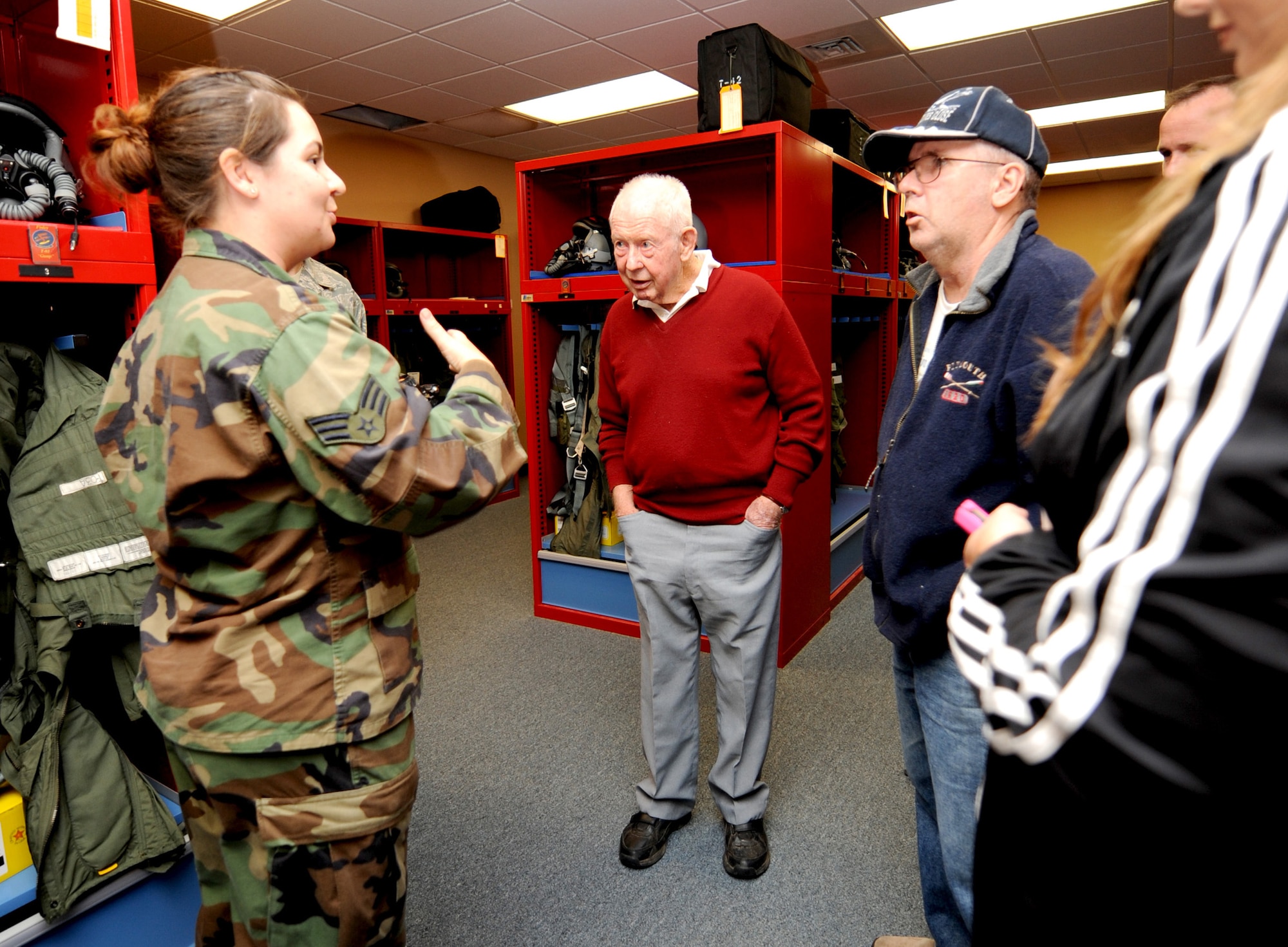 MOUNTAIN HOME AIR FORCE BASE, Idaho -- Senior Airman Christine Schoep, 389th Fighter Squadron aircrew flight equipment, speaks to retired Col. Bernard Fisher and other retirees about life support equipment during a base visit Aug. 7 at the 389th FS. Colonel Fisher is the first living U.S. Air Force recipient of the Medal of Honor for actions on March 10, 1966. President Lyndon Johnson awarded Colonel Fisher the medal on Jan. 19, 1967. (U.S. Air Force photo/ Senior Airman Samantha S. Crane)