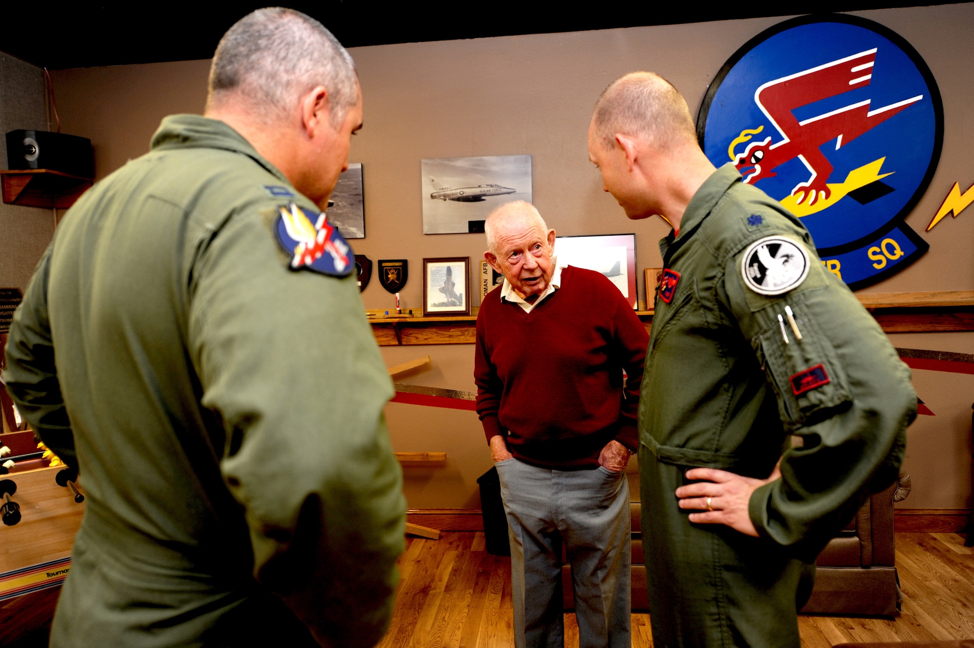 MOUNTAIN HOME AIR FORCE BASE, Idaho -- Retired Col. Bernard Fisher speaks with Capt. Nate “Kong” Owen (left), 389th Fighter Squadron pilot, and Lt. Col. Chris “Lazur” Bergstol, 366th Fighter Wing director of staff, during a base visit Aug. 7 in the 389th FS heritage room. Colonel Fisher was the first living U.S. Air Force recipient of the Medal of Honor for actions on March 10, 1966. President Lyndon Johnson awarded Colonel Fisher the medal on Jan. 19, 1967. (U.S. Air Force photo/ Senior Airman Samantha S. Crane)