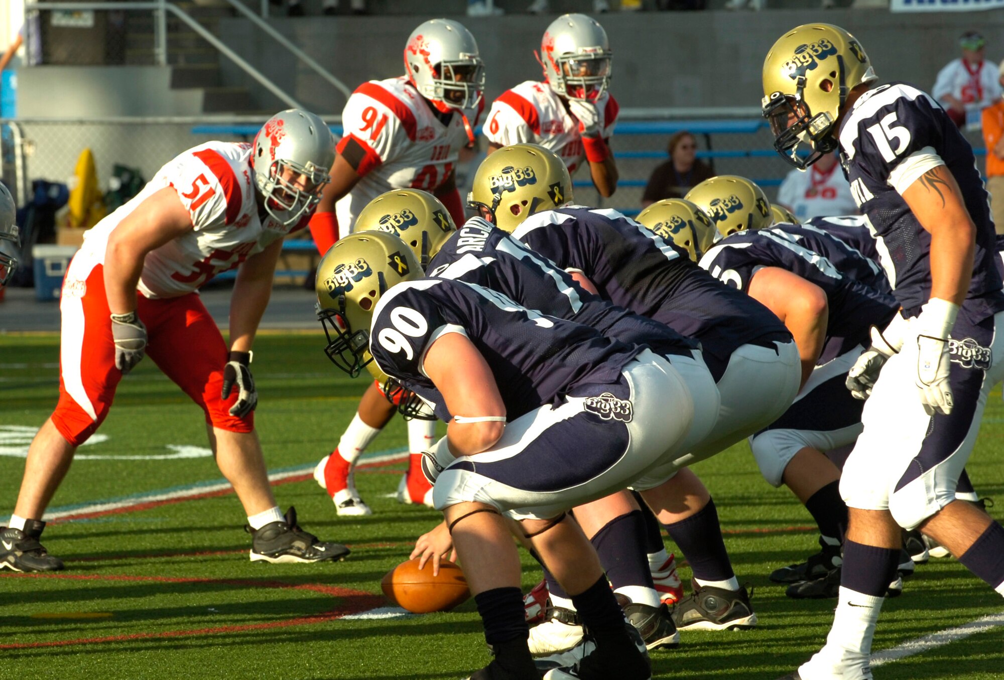 Players from Pennsylvania line up for a play while paying tribute to the 34 Soldiers from the Pennsylvania National Guard who made the ultimate sacrifice during the wars in Iraq and Afghanistan.  Specially deisgned helmet stickers were worn by both Pennsylvania and Ohio players.  Photo by Emily Phillippy.