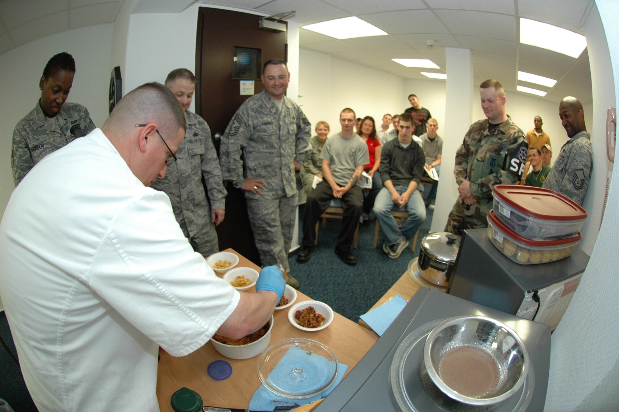 KAPAUN AIR STATION, Germany—Master Sgt. James Fuller, senior enlisted aide to the U.S. Air Forces in Europe commander, prepares bowls of chili for taste testing during a microwave cooking demonstration he did for the 569th U.S. Forces Police Squadron dorm residents.  Sponsored by the USAFE command chief’s office, Sergeant Fuller did the demo to help the dorm residents, who have no kitchen facilities, prepare wholesome meals in the microwave. (U.S. Air Force photo by Master Sgt. Corey Clements)