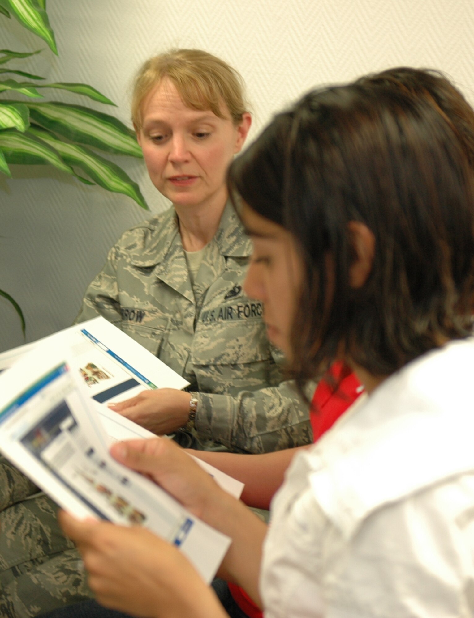 KAPAUN AIR STATION, Germany—U.S. Air Forces in Europe Command Chief Master Sgt. Pamela A. Derrow and Airmen from the 569th U.S. Forces Police Squadron view a handout about a Community of Practice web page called “Culinary Cues” during a microwave cooking demonstration. The page was established by Master Sgt. James Fuller, senior enlisted aide to the USAFE commander, to give Airmen recipes, cooking tips, culinary website references, and forums to ask questions about microwave cooking.  Sponsored by the USAFE command chief’s office, Sergeant Fuller did the demo and page to help 569th USFPS dorm residents, who have no kitchen facilities, prepare wholesome meals in the microwave. (U.S. Air Force photo by Master Sgt. Corey Clements)