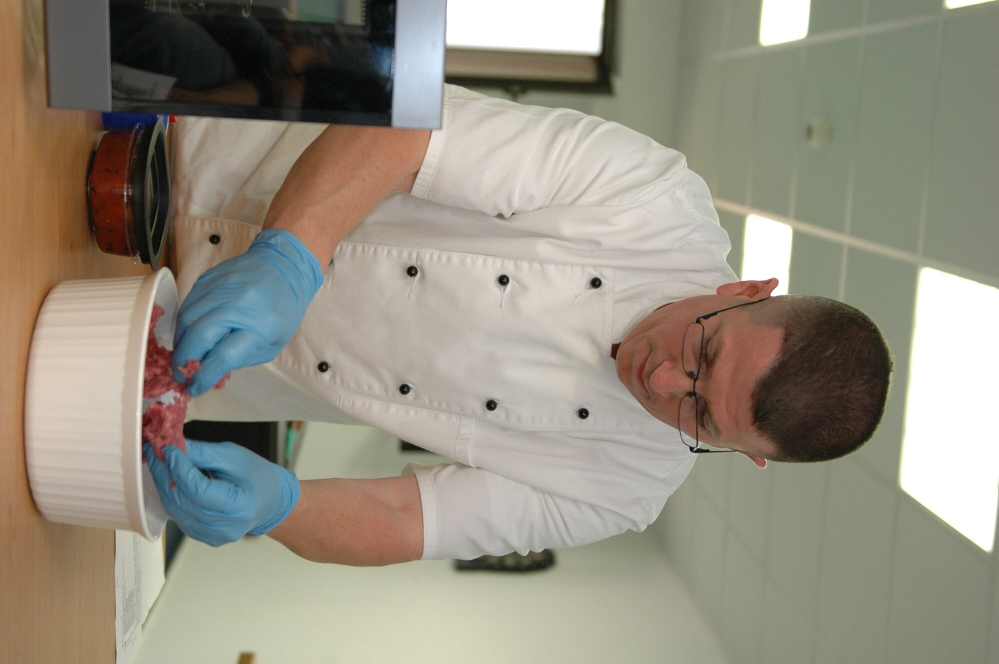 KAPAUN AIR STATION, Germany—Master Sgt. James Fuller, senior enlisted aide to the U.S. Air Forces in Europe commander, prepares ground beef for a chili during a microwave cooking demonstration.  Sponsored by the USAFE command chief’s office, Sergeant Fuller did the demo to help 569th U.S. Forces Police Squadron dorm residents, who have no kitchen facilities, prepare wholesome meals in the microwave. (U.S. Air Force photo by Master Sgt. Corey Clements)