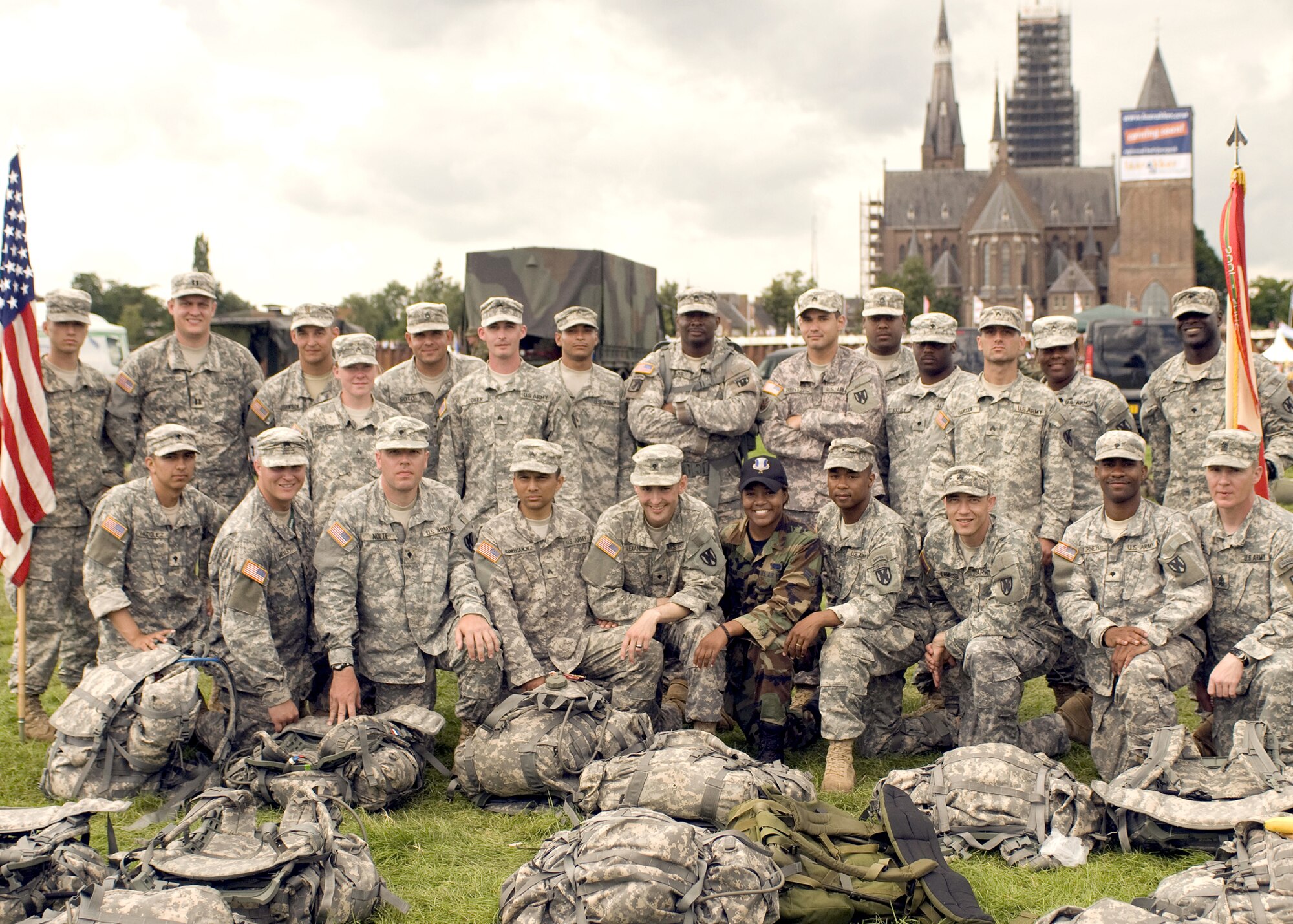 Senior Airman Saretta Morgan (BDUs), 86th Airlift Wing Legal Office parelegal, poses with her Army team mates after completing the International Four Day Marches Nijmegen in the Netherlands July 24. (Photo courtesy of the 21st Theater Sustainment Command)