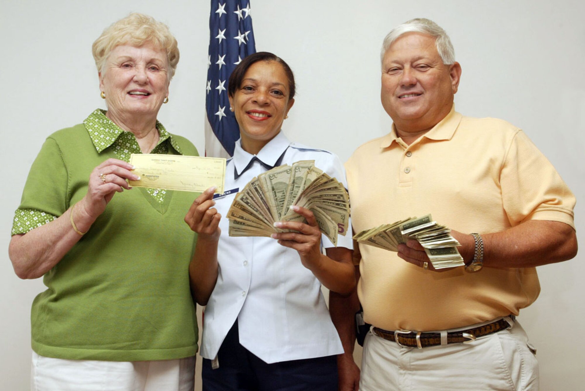 Ms. Nancy Black, manager of the Dobbins Thrift Store, and Chief Master Sgt. (Ret) Dallas Godfrey present Tech. Sgt. Cynthia Owens from the 94th Airlift Wing Family Readiness Center with $2,080.00 dollars for the Family Readiness Emergency Fund. The money was generated from $1,080.00 in proceeds raised at the annual Corn and Sausage Roast July 15 and $1,000.00 dollars donated by the Thrift Store.