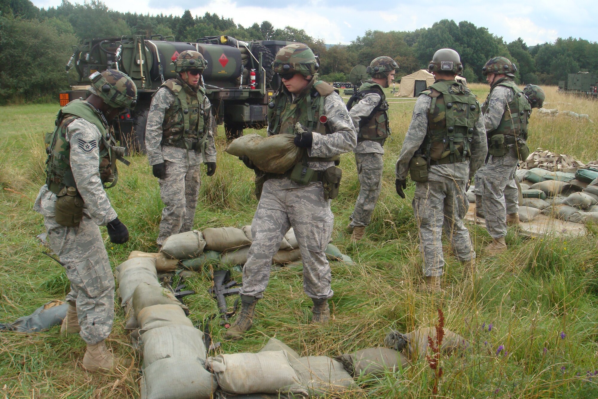 SPANGDAHLEM AIR BASE, Germany -- Members of the 606th Air Control Squadron construct a modified defensive fighting position Aug. 3 during a combat readiness training exercise near Gerolstein, Germany, held Aug. 3-7. The training exercise was part of a two-week Combat Readiness Training class that taught squadron members how to defend a deployed site without outside support. (U.S. Air Force photo/Staff Sgt. Daniel Heise)