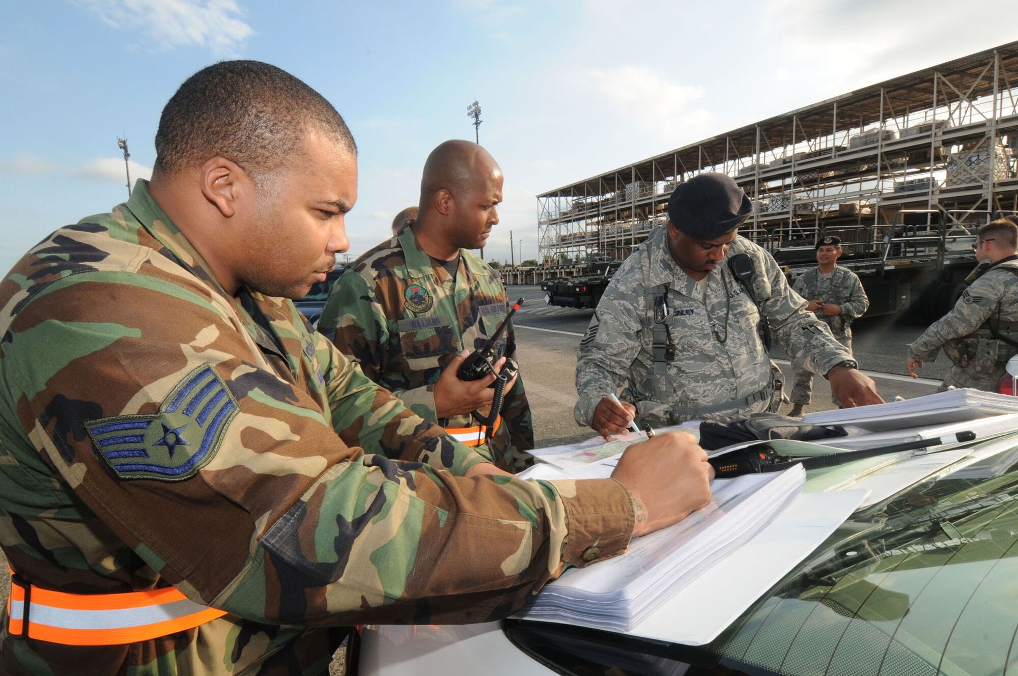 YOKOTA AIR BASE, Japan -- (Left to right) Staff Sgt. Johnny Truesdale, Tech. Sgt. Carles Williams, 374th Civil Engineer Squadron fire department, and Master Sgt. Robert Maginley, 374th Security Forces Squadron, plot coordinates on a map to determine what buildings need to be  evacuated during a simulated bomb threat,Aug. 11, during exercise Beverly-Morning 09-06. Yokota is conducting a phase I and II exercise Aug. 11-14 to prepare for an upcoming operational readiness inspection. (U.S. Air Force photo/Staff Sgt. Veronica Pierce)