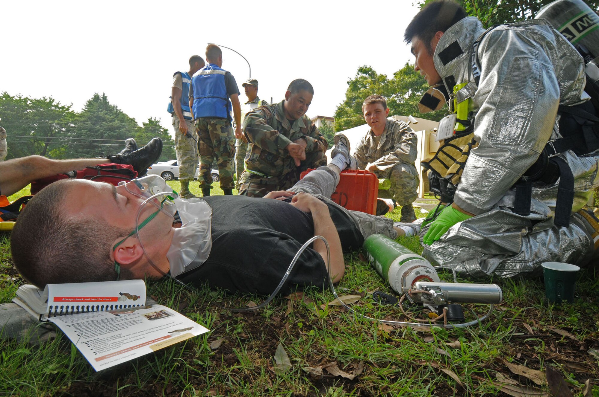 YOKOTA AIR BASE, Japan -- Airman 1st Class Brandon Lee, 36th Airlift Squadron loadmaster, receives self aid buddy care for simulated third-degree burns during exercise Beverly-Morning 09-06 Aug. 11. Yokota is conducting a phase I and II exercise Aug. 11-14 to prepare for an upcoming operational readiness inspection. (U.S. Air Force photo/Staff Sgt. Veronica Pierce)