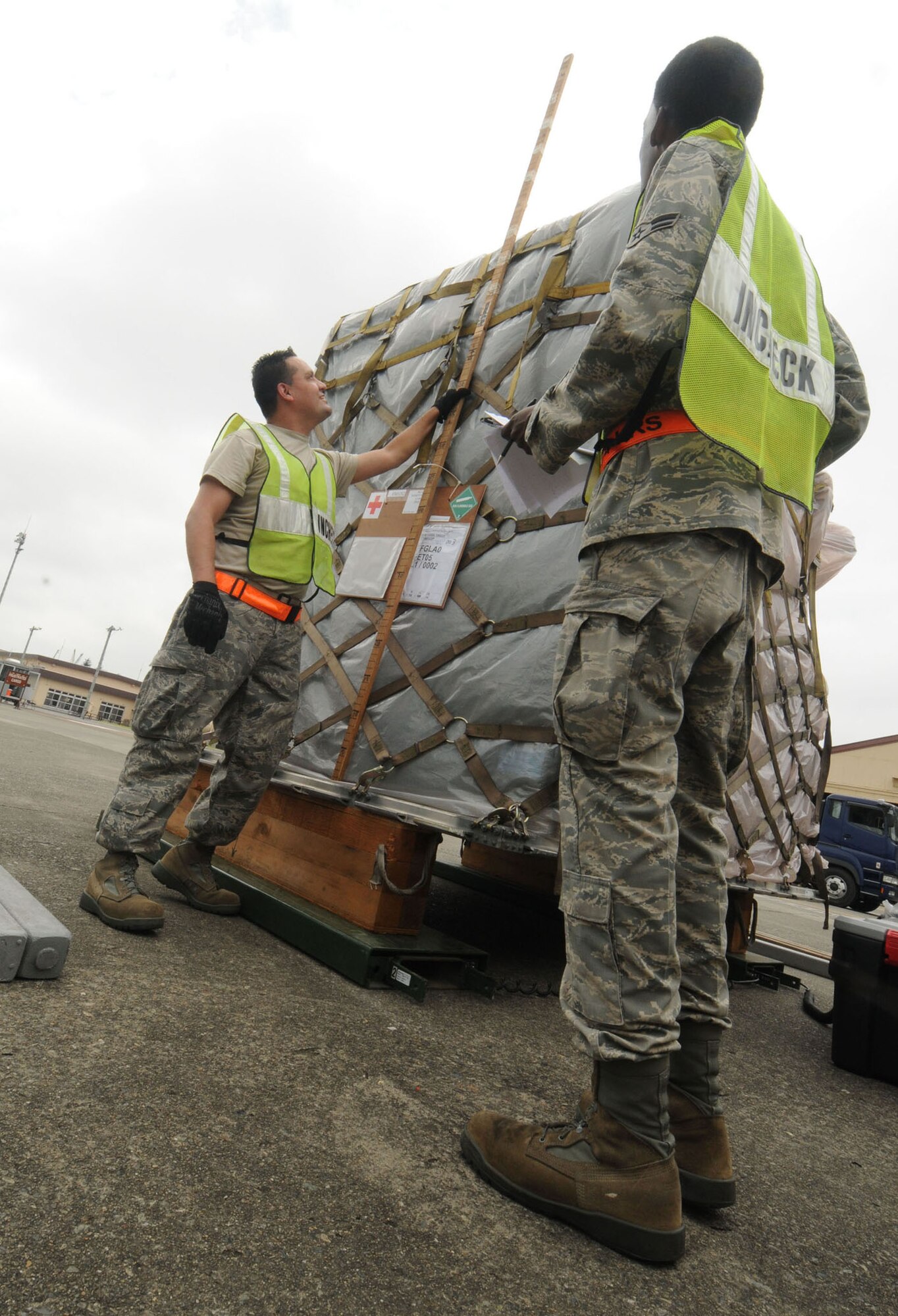 YOKOTA AIR BASE, Japan -- Staff Sgt. Paulino De Avila, 374th Logistics Readiness Squadron vehicle maintenance, and  Airman 1st Class Jamal Manjang, 374th LRS Traffic Management Office, take measurements of medical supply cargo during exercise Beverly-Morning 09-06 Aug. 11. Yokota is conducting a phase I and II exercise Aug. 11-14 to prepare for an upcoming operational readiness inspection. (U.S. Air Force photo/Staff Sgt. Veronica Pierce)
