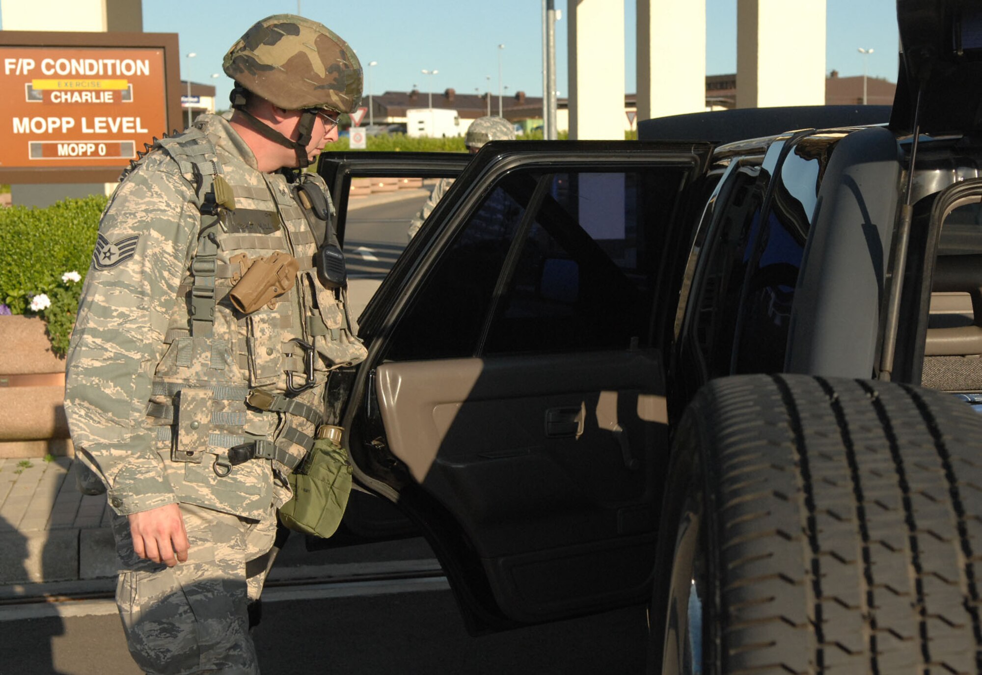 SPANGDAHLEM AIR BASE, Germany -- Staff Sgt. Joseph Null, 52nd Security Forces Squadron, inspects a vehicle at the front gate Aug. 4 during a base-wide exercise in preparation for a NATO Tactical Evaluation scheduled for 2010. For elevated security conditions, it is protocol for security forces to inspect every vehicle that comes through the gate. (U.S. Air Force photo /Airman 1st Class Nick Wilson)