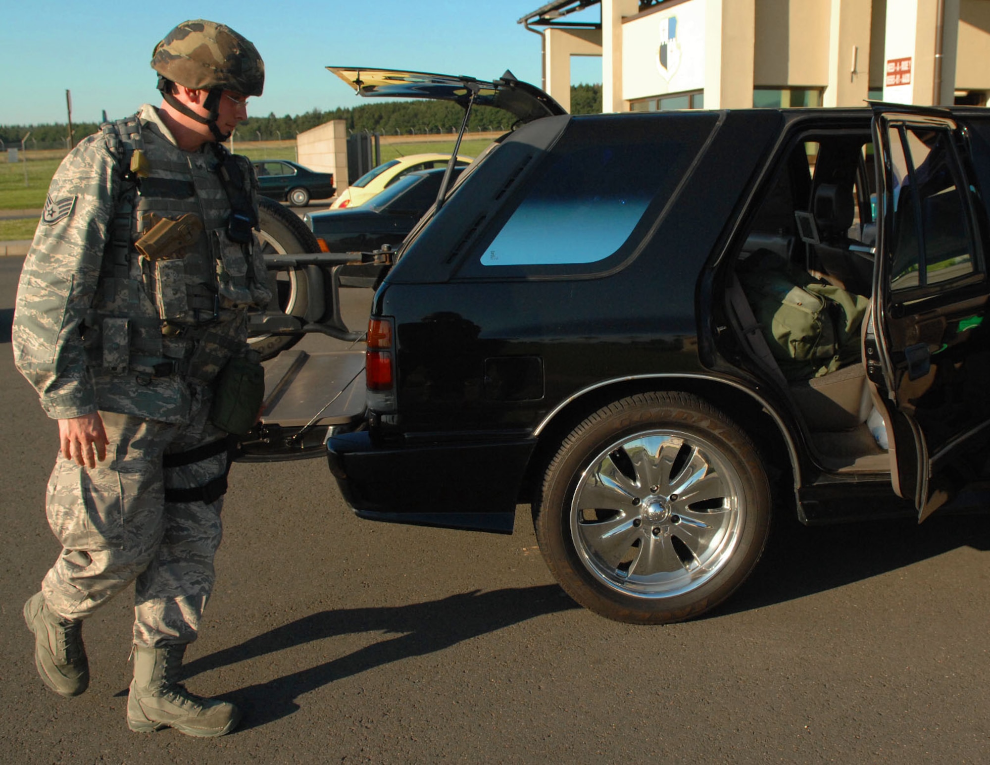 SPANGDAHLEM AIR BASE, Germany -- Staff Sgt. Joseph Null, 52nd Security Forces Squadron, inspects a vehicle at the front gate Aug. 4 during a base-wide exercise in preparation for a NATO Tactical Evaluation scheduled for 2010. For elevated security conditions, it is protocol for security forces to inspect every vehicle that comes through the gate. (U.S. Air Force photo /Airman 1st Class Nick Wilson)