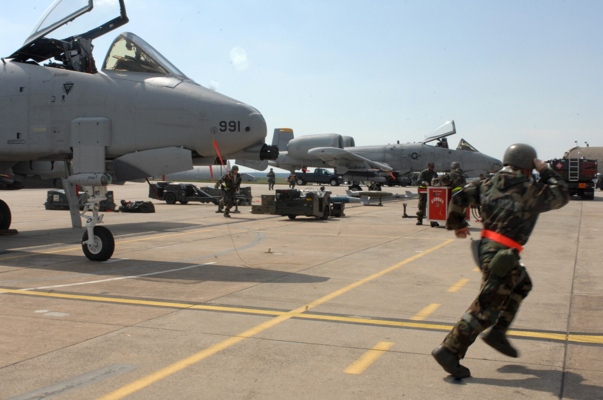 SPANGDAHLEM AIR BASE, Germany -- Members of the 52nd Aircraft Maintenance Squadron, 52nd Equipment Maintenance Squadron, and 81st Fighter Squadron take shelter inside hangars 1 and 2 Aug. 6 during the 52nd Fighter Wing’s Phase II exercise. During a simulated attack, Airmen responded to attack warning signals for simulated chemical and ground attacks. (U.S. Air Force photo/Senior Airman Jenifer H. Calhoun)