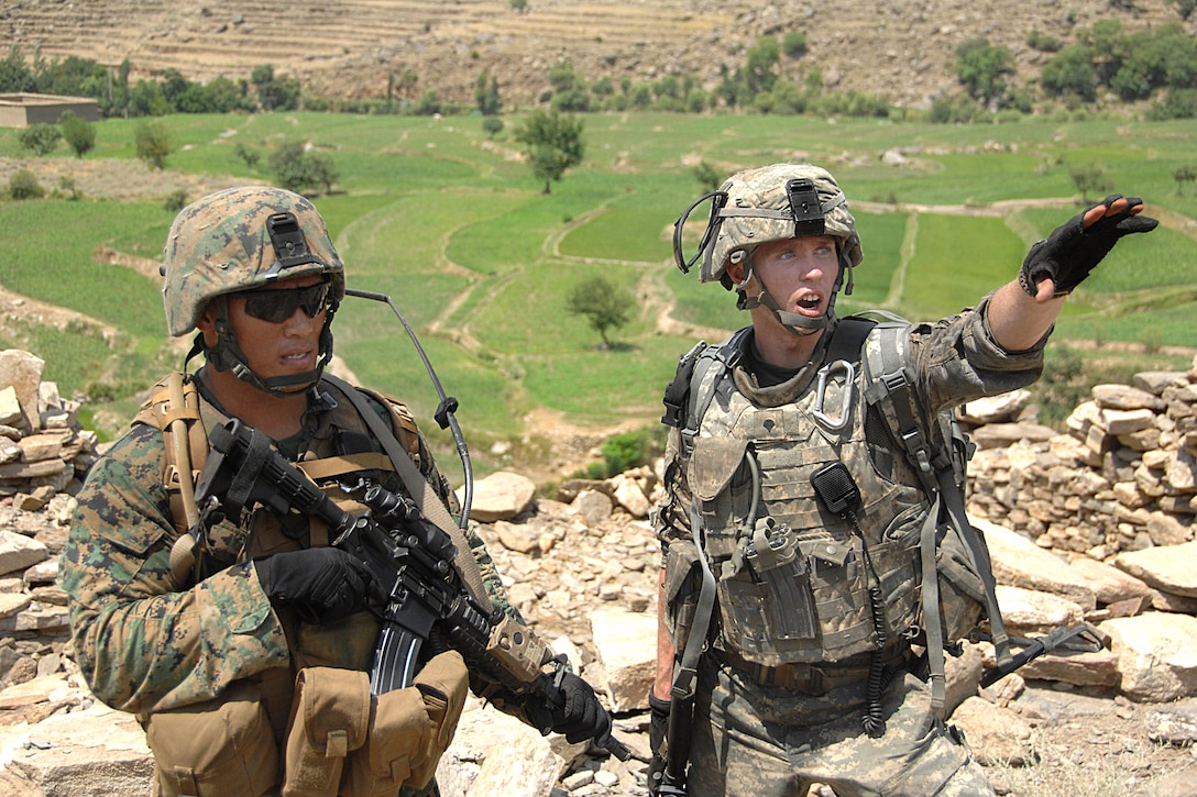 U.S. Army Spc. Henry Rosenquist and a U.S. Marine locate enemy forces during a patrol near Combat Outpost Honaker Miracle in Konar province, Afghanistan, July 29,  2009. Rosenquist and the Marine are assigned to Company C, 2nd Battalion, 12th Infantry Regiment, Task Force Mountain Warrior. U.S. and Afghan forces were patrolling the area on the way to a meeting with village elders.