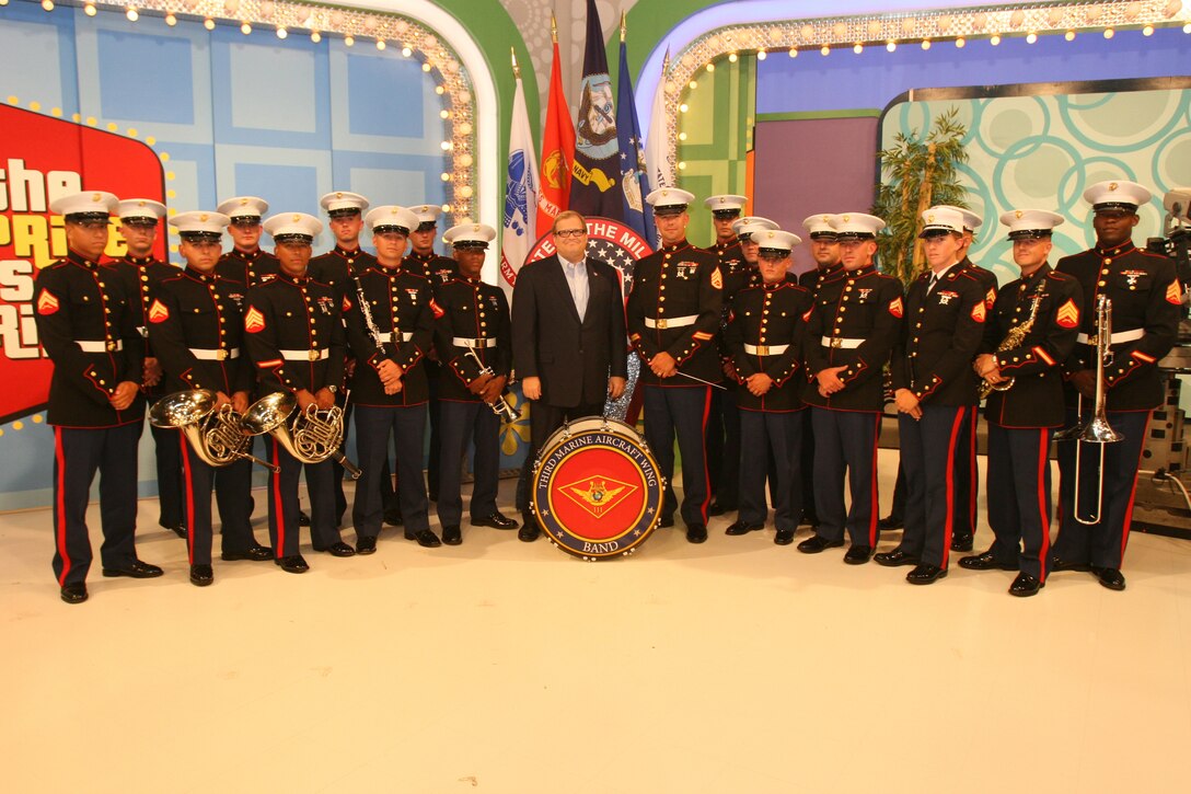 Marines from the 3rd Marine Aircraft Wing Band stand with Drew Carrey after they lent their musical talent for the Veterans Day "Salute to the Military" episode of CBS's "The Price is Right," Aug. 11, in Los Angeles. Service members from all of the branches attended the taping and some competed for prizes. (Official U.S. Marine Corps photo by Cpl. Christopher O'Quin)