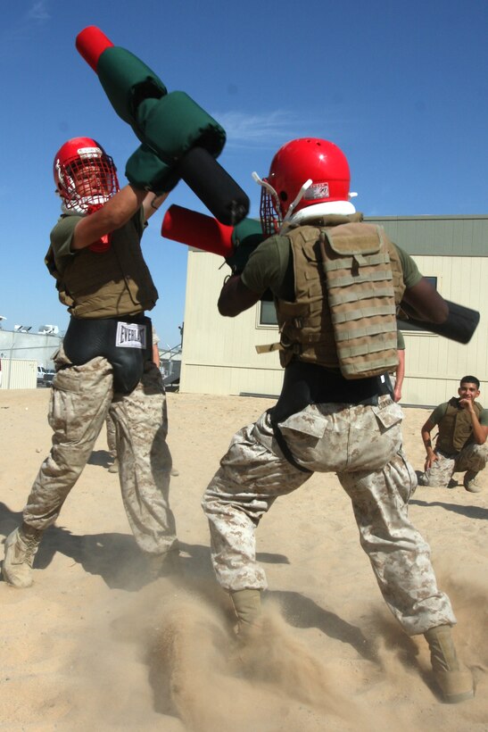 Students in the 3rd Combat Engineer Battalion’s Marine Corps Martial Arts Program gray belt course, duke it out during a pugil sticks bout at the battalion’s headquarters here Aug. 12. The Marines still have several training requirements to accomplish before being tested on their proper execution of the moves Friday.::r::::n::