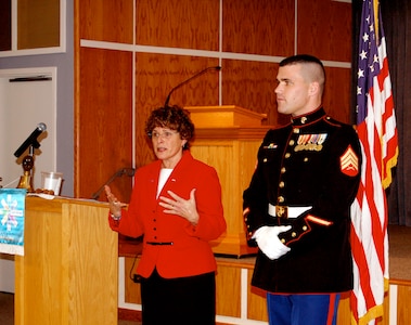 U.S. Marine Staff Sgt. Crowley is awarded a Quilt of Valor from Catherine Roberts, the founder of the Quilts of Valor Foundation, at the Nanticoke Rotary Club in Seaford, Del., Nov. 29, 2006. (Photo courtesy of Catherine C. Roberts, Quilts of Valor Foundation)