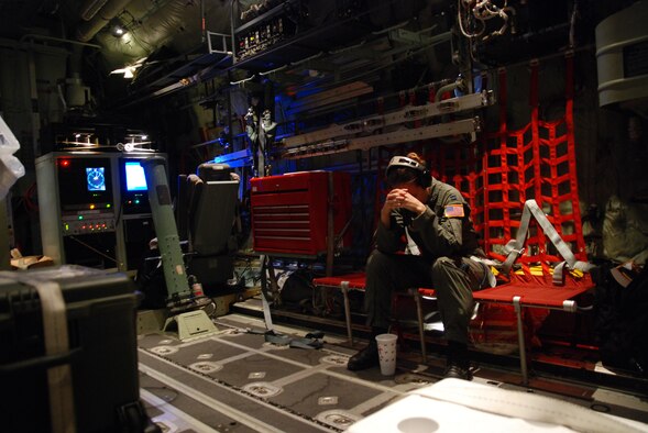 HICKAM AIR FORCE BASE -- Capt. Ellen Bundy, a 53rd Weather Reconnaissance Squadron meteorologist, prepares for an early morning flight into tropical storm Felicia. The unit, also known as the Hurricane Hunters, operate the WC-130J aircraft for weather reconnaissance into some of the most violent storms on Earth -- tropical cyclones. Hurricane Felicia reached peak strength as a Category 4 storm with sustained winds of more than 145 mph. The 53rd WRS is a one-of-a-kind U.S. Air Force Reserve unit and the only Department of Defense organization still flying into tropical storms and hurricanes since 1944. Their fleet of 10 Lockheed-Martin WC-130J aircraft and crews are part of the 403rd Wing, based at Keesler Air Force Base, Biloxi, Miss. (U.S. Air Force photo/Staff Sgt. Mike Meares)