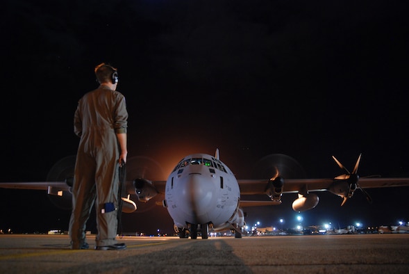 HICKAM AIR FORCE BASE -- Tech. Sgt. Matt Couch, 53rd Weather Reconnaissance Squadron loadmaster, communicates with the pilot as they prepare for a ten-hour mission into the remnant of Hurricane Felicia Aug. 9. Hurricane Felicia reached peak strength as a Category 4 storm with sustained winds of more than 145 mph. The 53rd WRS is a one-of-a-kind U.S. Air Force Reserve unit and the only Department of Defense organization still flying into tropical storms and hurricanes since 1944. Their fleet of 10 Lockheed-Martin WC-130J aircraft and crews are part of the 403rd Wing, based at Keesler Air Force Base, Biloxi, Miss. (U.S. Air Force photo/Staff Sgt. Mike Meares)
