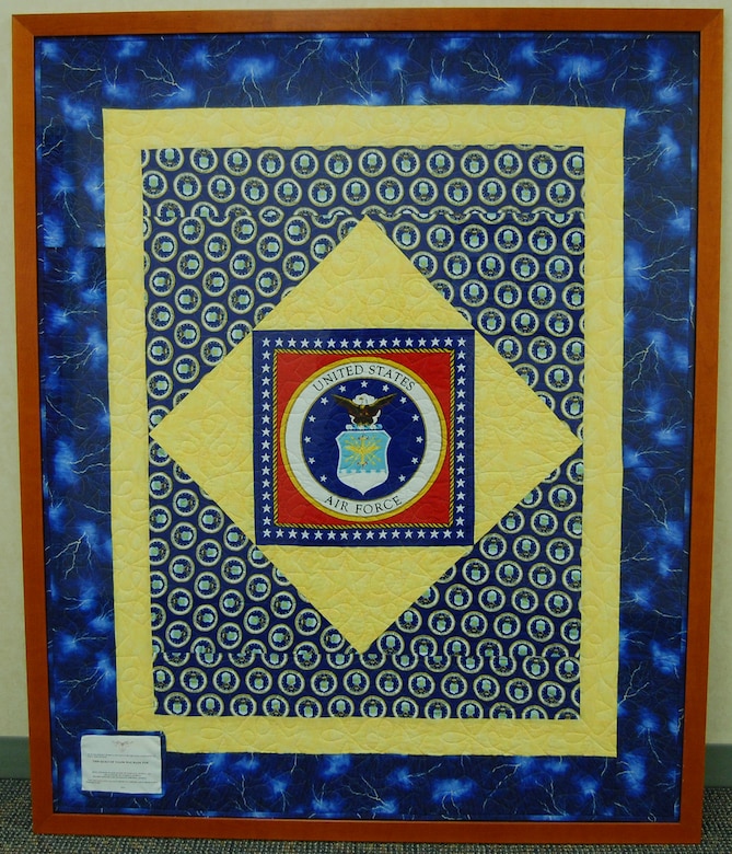 Quilters from Valdosta and Norcross, Ga., made this Quilt of Valor in 2009 for the Air Force Mortuary Affairs Operations Center located at Dover A.F.B., Del. The framed quilt is on the wall of the center's main hallway (U.S. Air Force photo/Master Sgt. Robert Jones)