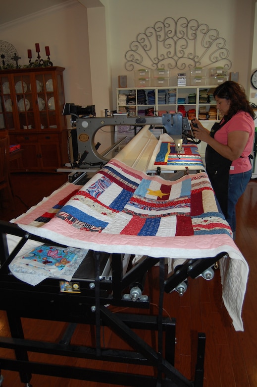 Irene Hafer of Dover, Delaware, works on a Quilts of Valor quilt on her longarm machine in her home studio June 24, 2009. (U.S. Air Force photo/Tech. Sgt. Benjamin Matwey)