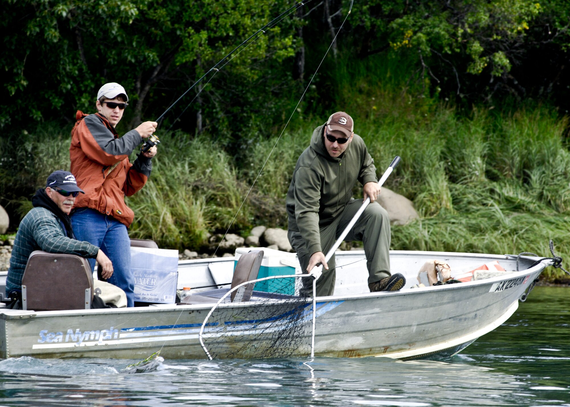 KING SALMON, Alaska -- Justin Bloomer helps net his son's fish Aug. 8. Bloomer, assigned to Fort Richardson's Alpha Company Warrior Transition Battalion-Alaska, and his son, Jalynn, participated in the first Bristol Bay American Heroes Fishing Derby Aug. 6-10. The derby allowed 11 Soldiers to take one of their children on a four day fishing trip to King Salmon. (U.S. Air Force Photo/Airman 1st Class Christopher Gross)