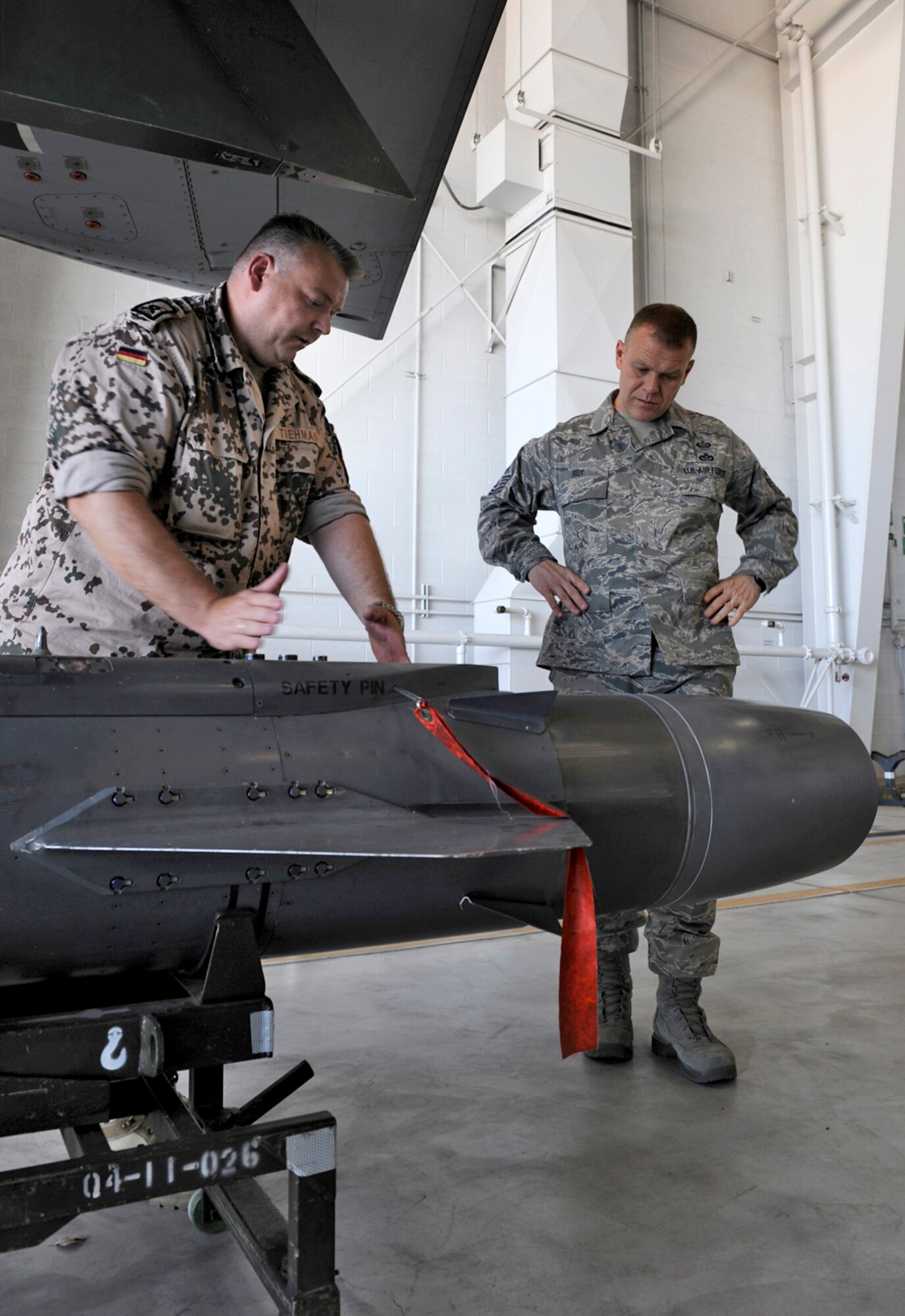 HOLLOMAN AIR FORCE BASE, N.M. -- Master Sgt. Joerg Tiehmann, German air force 1st Line Maintanence supervisor of the Training and Standardisation team, talks with Chief Master Sgt. of the Air Force James Roy about the weapon capabilities of the German aircraft, the Tornado. Chief Roy toured the base, talked to Airmen and answered their questions. (U.S. Air Force photo by Senior Airman Tiffany Trojca)