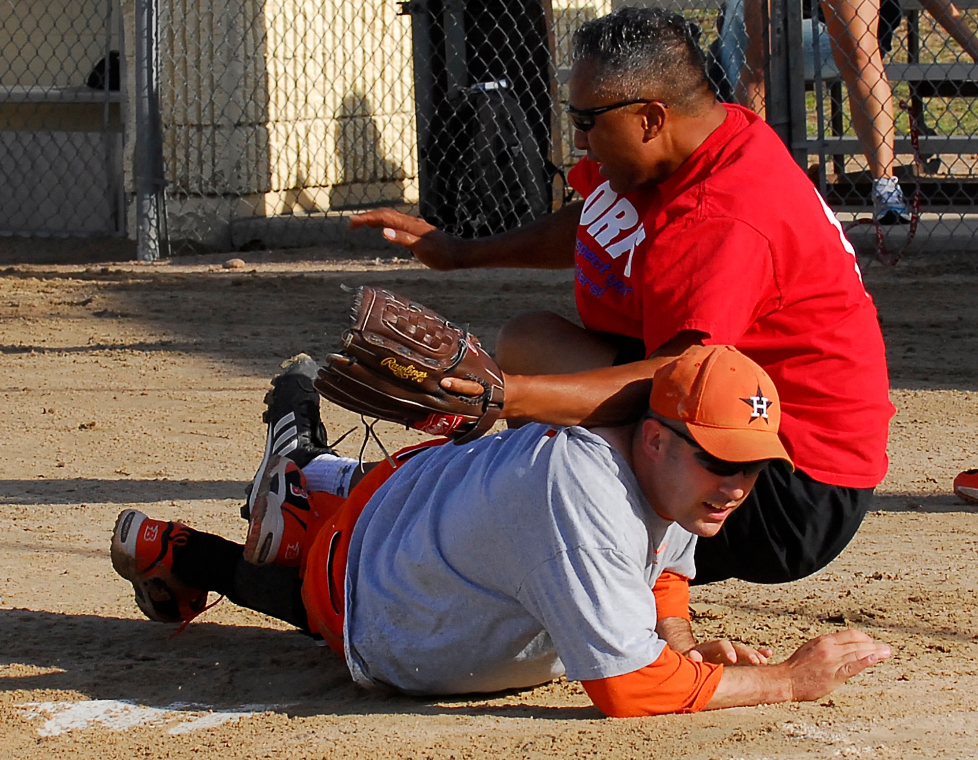 The Retirees' Tevita Mafi tries to catch Med Group One's Fred Walker out at home plate during the Intramural Softball Championship. The Med Group won the championship game, 28-20. (U.S. Air Force photo/Rachel Boettcher)