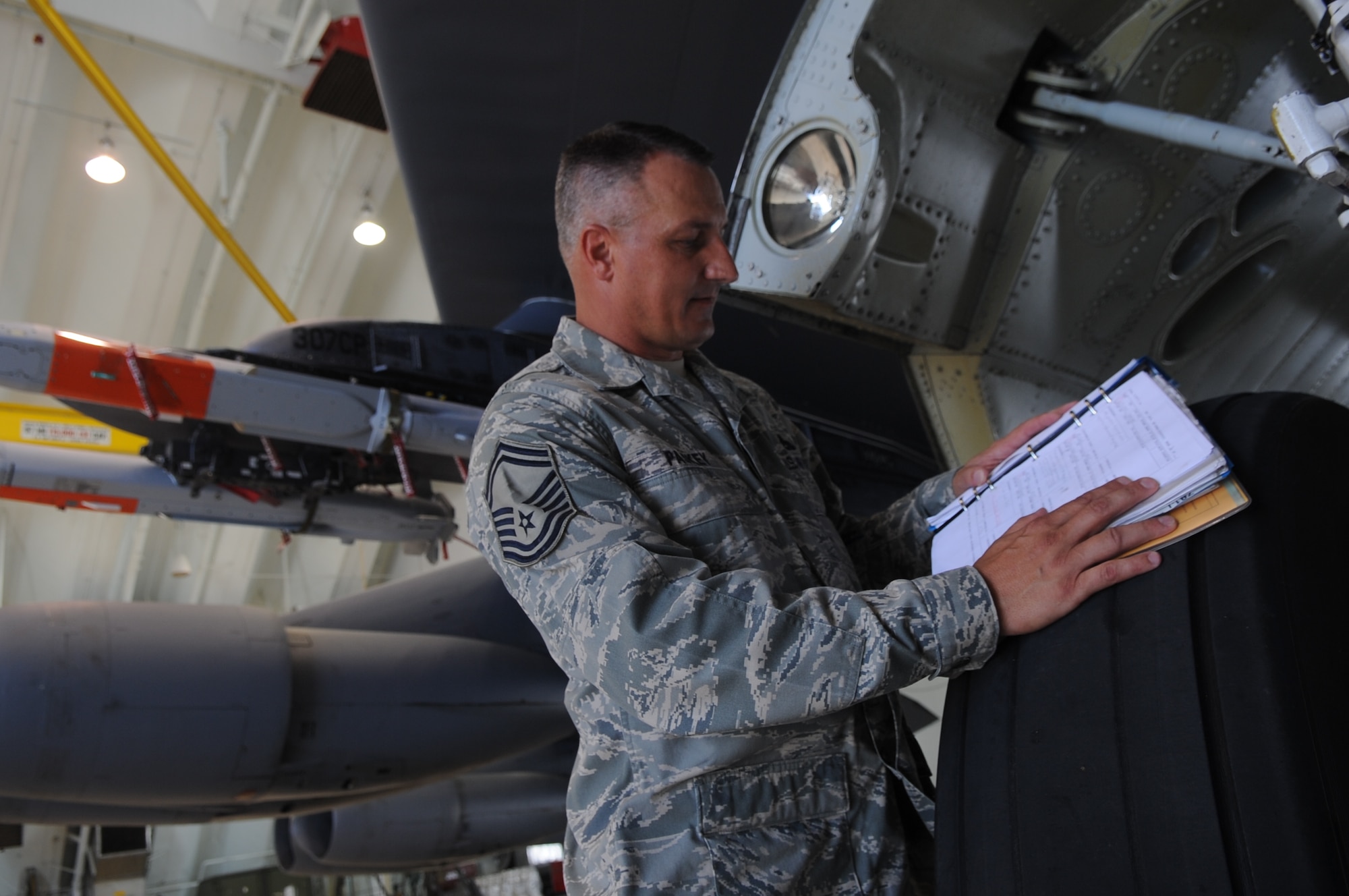 Senior Master Sgt. Carl Paskey looks at a technical order Aug. 11 on a B-52 Stratofortress while deployed to Andersen Air Force Base, Guam. Sergeant Paskey is the 96th Expeditionary Aircraft Maintenance Unit lead production superintendent. The Orwell, Ohio, native has been to Guam 31 times over 11 years.  He is currently deployed to Andersen supporting U.S. Pacific Command’s Continuous Bomber Presence mission in the Asia-Pacific region. (U.S. Air Force photo/Senior Airman Christopher Bush)
