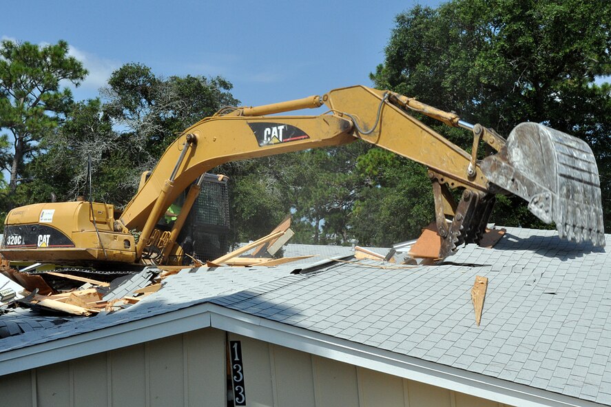 EGLIN AIR FORCE BASE, Fla. – An excavator demolishes a house in base housing. The demolition is part of an effort to destroy old, inadequate units to improve the quality of life for base housing residents. (U.S. Air Force photo/ Airman Anthony Jennings)