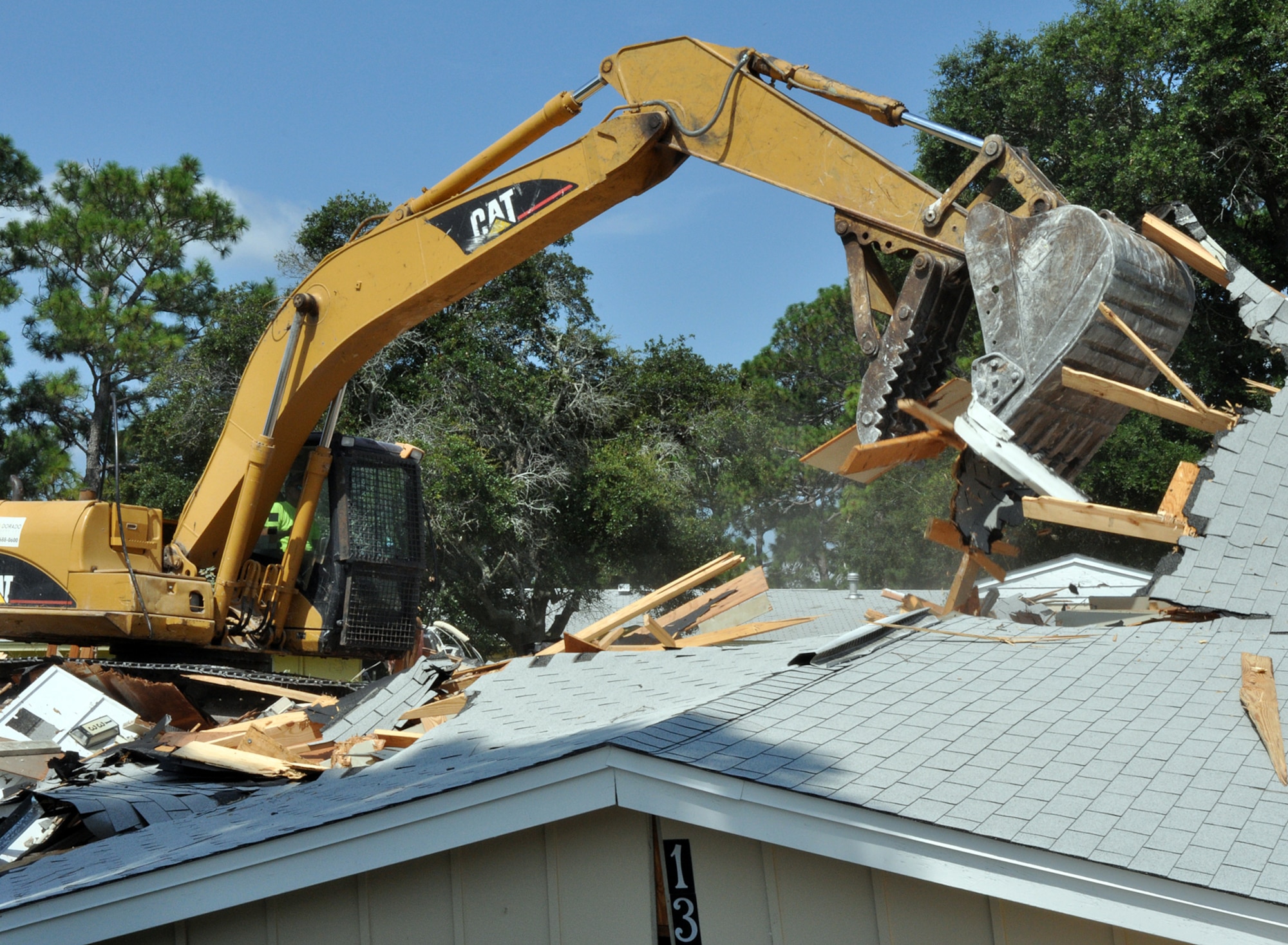 EGLIN AIR FORCE BASE, Fla. – An excavator demolishes a house in base housing. The demolition is part of an effort to destroy old, inadequate units to improve the quality of life for base housing residents. (U.S. Air Force photo/ Airman Anthony Jennings)