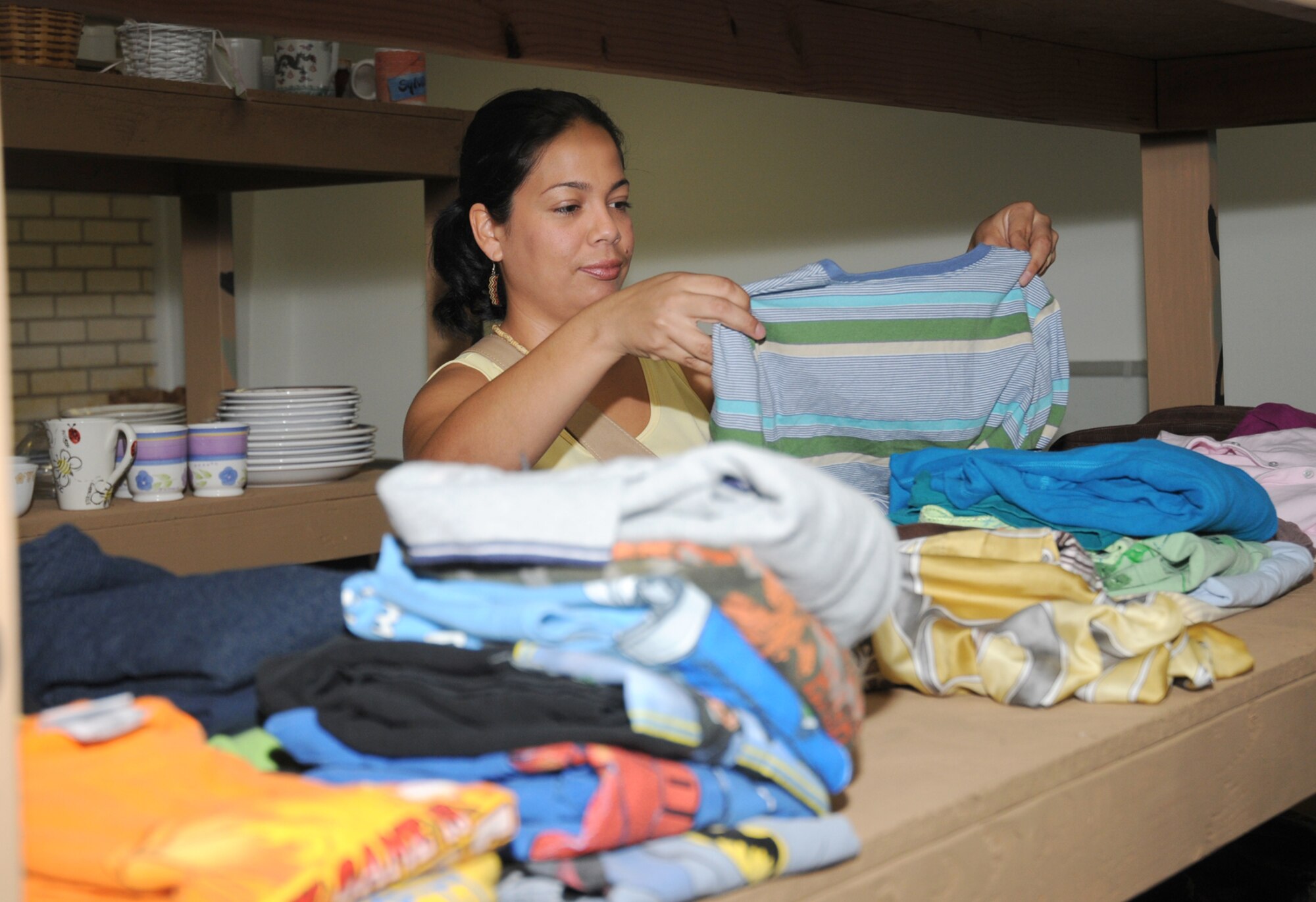 Juliana Calero looks at clothing items at Airman’s Attic Monday.  Her husband is Airman 1st Class Gilbert Quijano, 81st Dental Squadron.  (U.S. Air Force photo by Kemberly Groue)