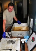 Senior Airman Brad Chambers removes tool sockets from a pan of cleaning solution during a rust removal inspection of a tool kit at the Viper support section here Aug. 12. The Viper support section performs regular derust inspections after heavy rainfall for corrosion control of tools and equipment needed to maintain Charleston AFB aircraft. Airman Chambers is a flightline support specialist with the 437th Aircraft Maintenance Squadron. (U.S. Air Force photo/Staff Sgt. Daniel Bowles)

