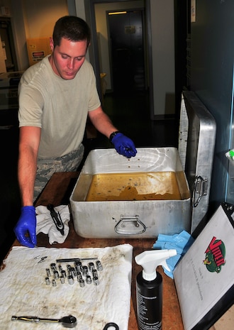 Senior Airman Brad Chambers removes tool sockets from a pan of cleaning solution during a rust removal inspection of a tool kit at the Viper support section here Aug. 12. The Viper support section performs regular derust inspections after heavy rainfall for corrosion control of tools and equipment needed to maintain Charleston AFB aircraft. Airman Chambers is a flightline support specialist with the 437th Aircraft Maintenance Squadron.