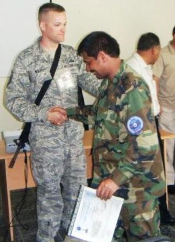 Master Sgt. Tracy Wolfe, a fuels complex instructor at the 364th Training Squadron, congratulates one of his students Aug.6 at their school house in Kabul, Afghanistan. Sergeant Wolfe instructed Kabul’s first Petroleum, Oils and Lubricants course. (U.S. Air Force photo/courtesy of 364th Training Squadron)