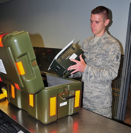 Senior Airman Jonathan Houghton inspects a Mode Four, Idenify Friend or Foe camera at the Blue Aircraft Maintenance Unit Support Section here Aug. 12. The IFF camera is used to transmit test codes to C-17 IFF antennas. Airman Houghton is a communications, navigations and mission systems journeyman with the 437th Aircraft Maintenace Squadron.