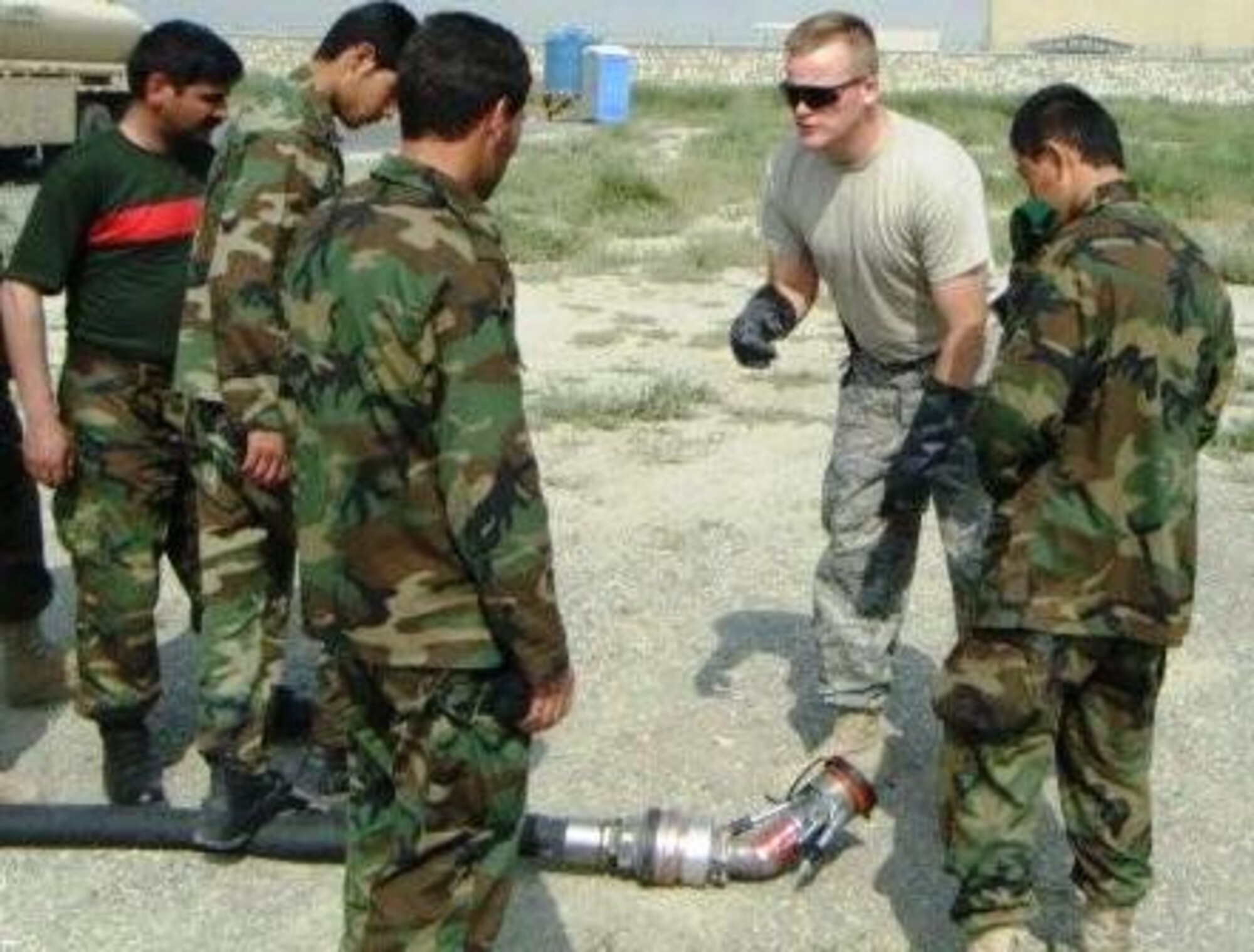 Master Sgt. Tracy Wolfe, a fuels complex instructor at the 364th Training Squadron, is teaching his students about the single point nozzle in Kabul, Afghanistan.  He taught subjects including information safety, vehicle inspection, facility inspection, forms and fueling operations through two blocks of instruction over a 33-day period. (U.S. Air Force photo/courtesy of 364th Training Squadron)