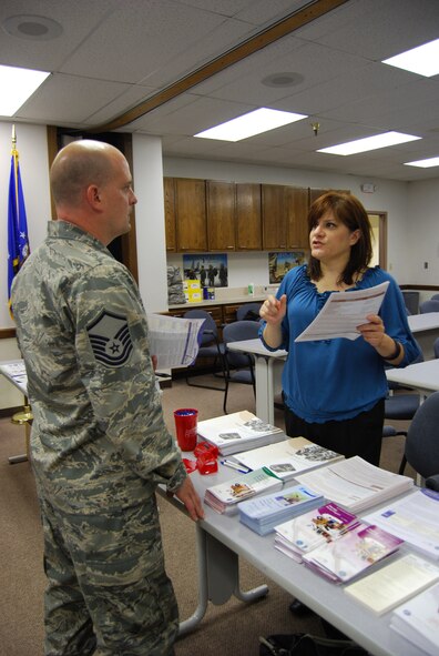 (At right) Susana Estrada-Berg, TRICARE beneficiary service representative, explains to Master Sgt. Michael Ellsworth, 26th Aerial Port Squadron assistant NCO in-charge of combat readiness, the different types of health care plans available to service members and their dependants before, during and after a deployment.  Represenaitives from more than a dozen organizations such as the Red Cross, the 433rd Airlift Wing legal office and the Employment Support for Guard and Reserve (ESGR) participated in a Yellow Ribbon Reintegration pre-deployment seminar, which took place Aug. 2, 2009 at the 26th Aerial Port Squadron headquarters building in San Antonio, Texas. 
The representatives presented information on deployment-related matters such as physical separation from loved ones, care or guardianship of dependants, family and individual counseling, employment rights and legal matters such as wills and powers of attorney documents. 
The Yellow Ribbon Program is designed to help service members and families prepare for the challenges encountered before, during and after a deployment. (U.S. Air Force photo/Senior Airman Luis Loza Gutierrez)
For more information about the Yellow Ribbon Reintegration Program use the following link: http://www.af.mil/news/story.asp?id=123123264 