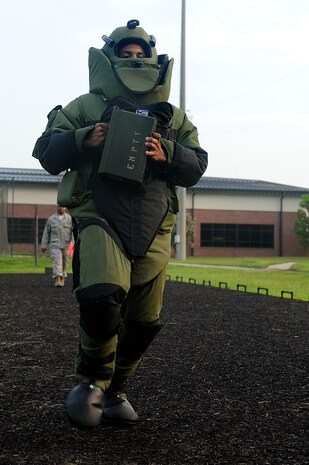 Staff Sgt. Javier Parris runs in the Explosive Ordnance Disposal bomb suit during the Commander’s Challenge August 7th. During this specific event each Airman had to do 10 push-ups, sprint to an ammo box, carry the ammo box back and complete another set of 10 push-ups all while wearing the bomb suit. Sergeant Parris is a maintainer with the 1st Combat Camera Squadron. (U.S. Air Force photo/Airman 1st Class Alexandra Hoachlander)
