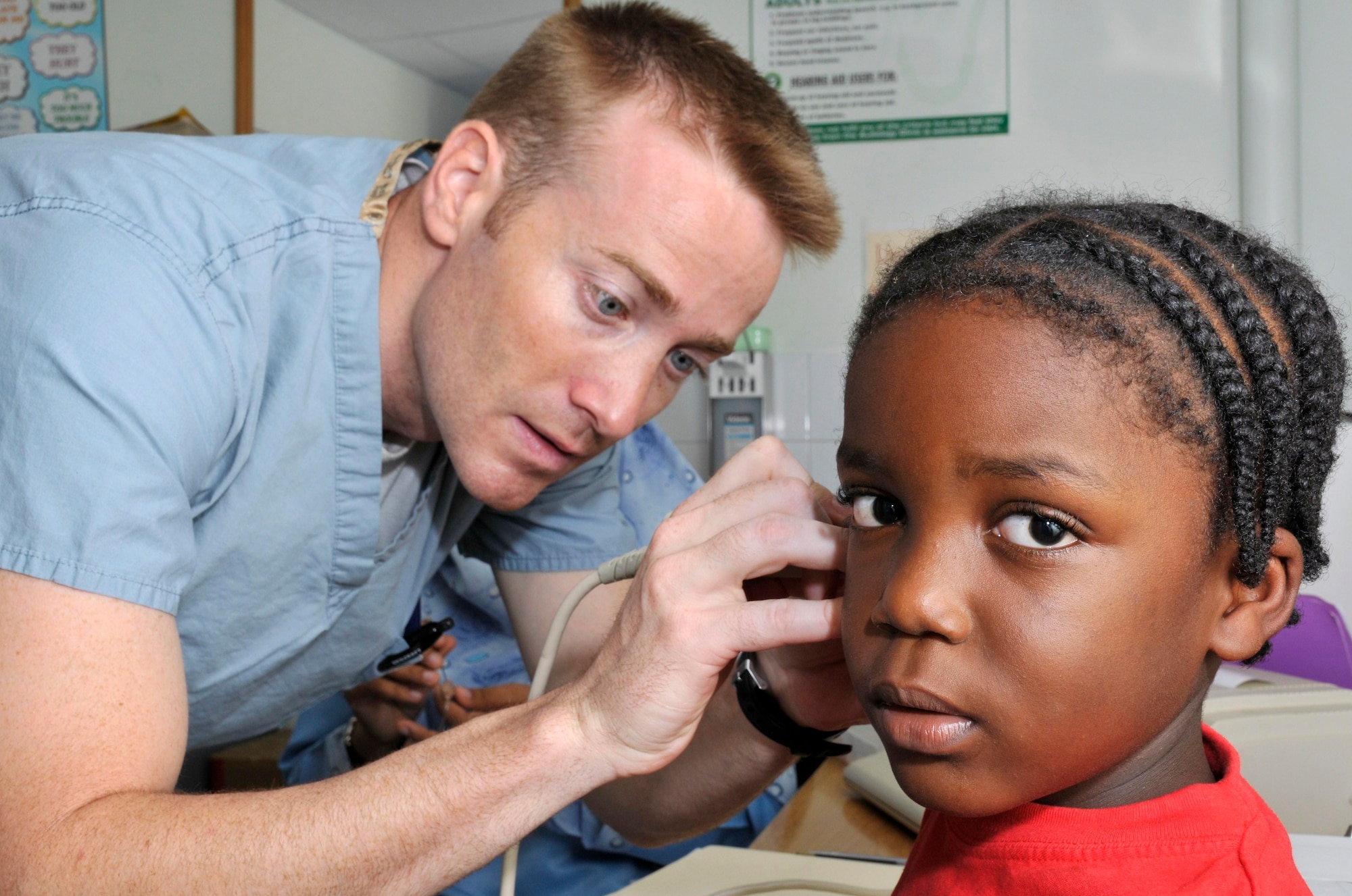 Capt. Johnny Foster, audiologist from the 59th Medical Wing at Wilford Hall, Lackland Air Force Base, Texas, uses a tympanometer to measure a Guyanese boy's eardrums Aug 11, 2009, at the Georgetown Public Hospital in Georgetown, Guyana. Ear, Nose, and Throat doctors deployed here wil see more than 500 patients in 8 days. (U.S. Air Force photo by Airman 1st Class Perry Aston) (Released)