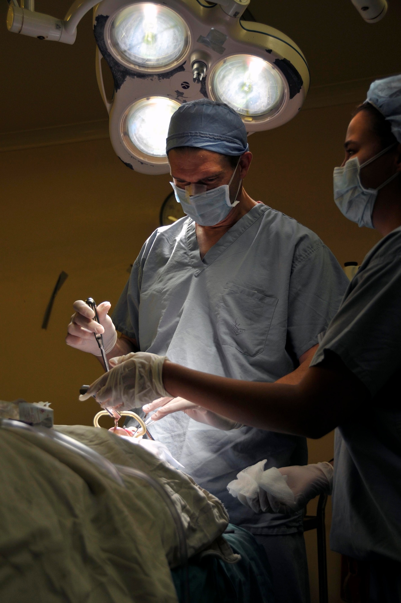 Lt. Col. Mark Packer, neuro-otologist from the 59th Medical Wing at Wilford Hall, Lackland Air Force Base, Texas, prepares the patient for surgery Aug 6, 2009, at the Georgetown Public Hospital in Georgetown, Guyana. Lt. Col. Packer is one of the sub-specialists for medical conditions of the ear, nose and throat that deployed here to provide free medical care to the Guyanese citizens.(U.S. Air Force photo by Airman 1st Class Perry Aston) (Released)