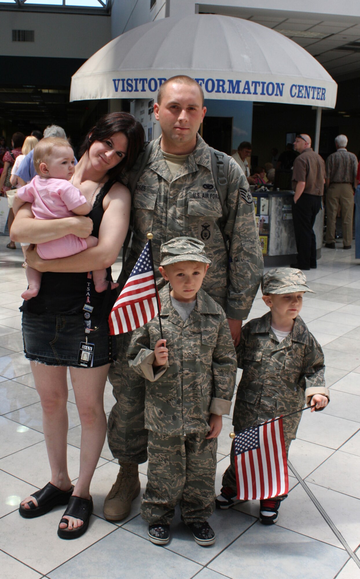 Staff Sgt. Adam Moses of the 445th Security Forces Squadron waits in the baggage claim area at the Dayton International Airport, Ohio, Aug. 6, 2009. Joining him are his wife, Sheila, holding their daughter Rayvin, and their older son Dante and younger son Kain. Sergeant Moses was one of 12 reservists from Wright-Patterson Air Force Base, Ohio, to return home after six months at Kirkuk Regional Air Base, Iraq. (U.S. Air Force photo/Stacy Vaughn) 


