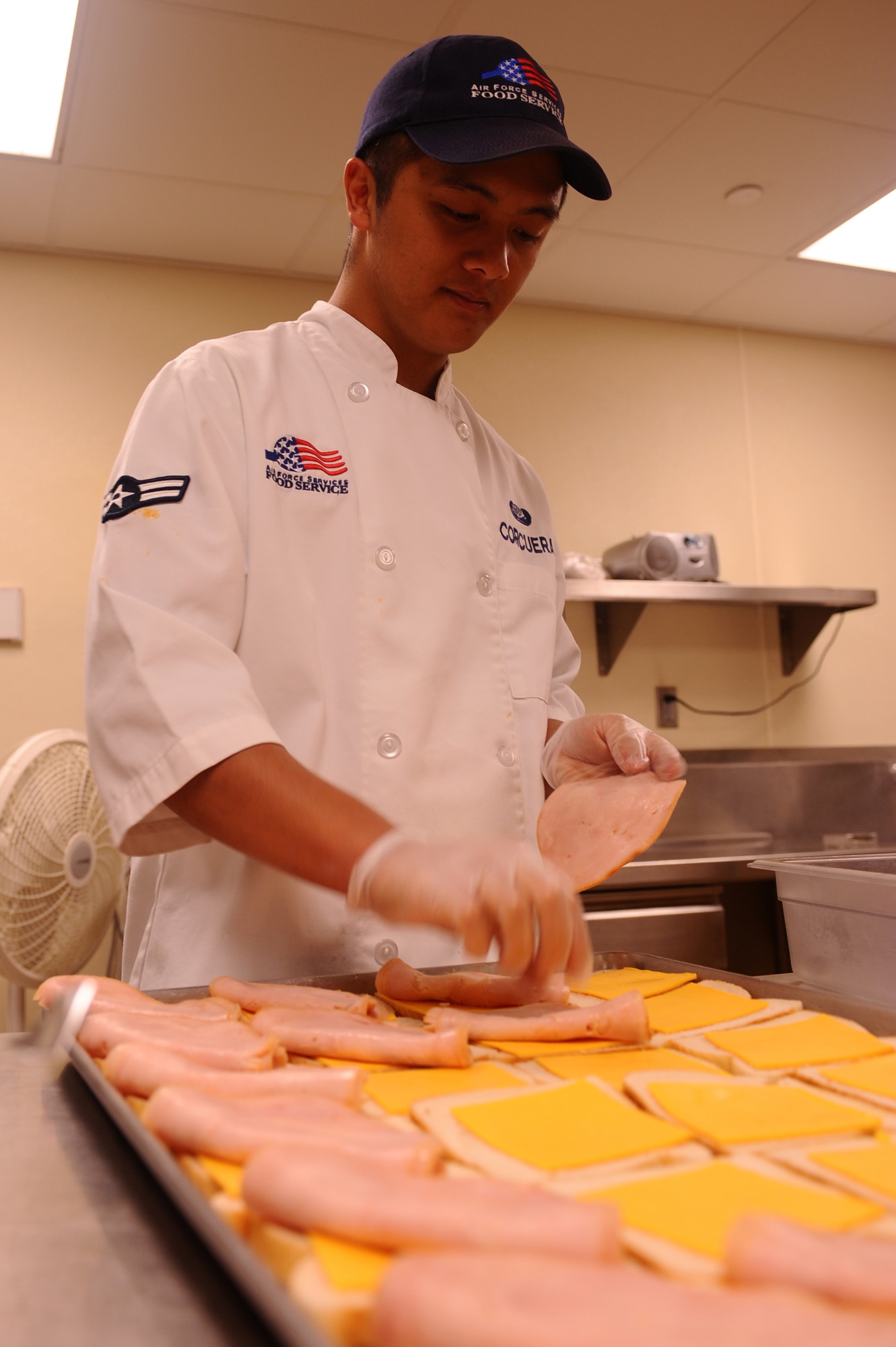 Airman 1st Class Roldan Corcuera, 28th Force Support Squadron food services journeyman, assembles turkey sandwiches for Airmen who come through the flight kitchen here, August 11. The flight kitchen operates 24 hours a day, providing hot meals and pre-made supplement bags containing various food items. (U.S. Air Force photo/Senior Airman Kasey Zickmund)