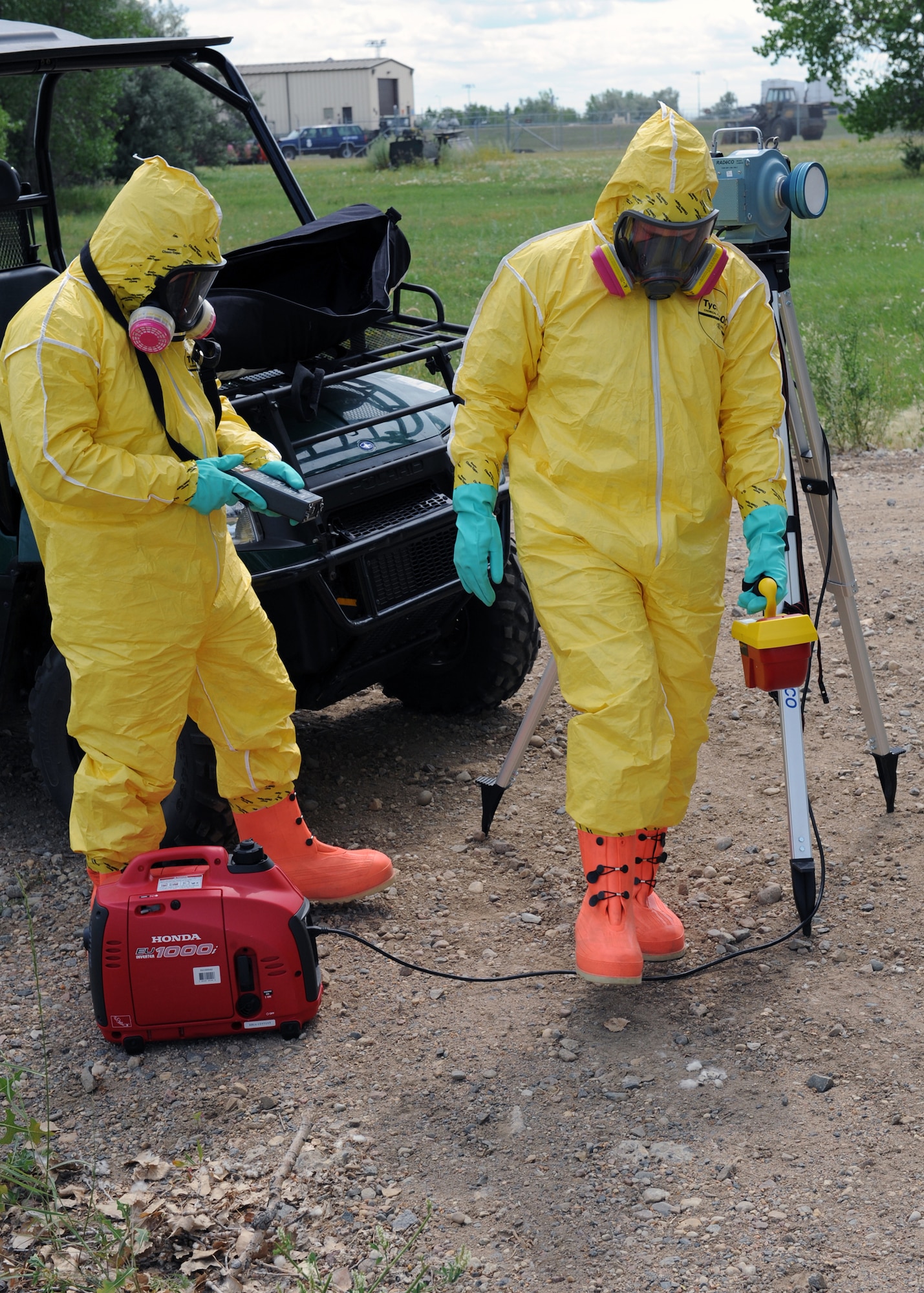 MINOT AIR FORCE BASE, N.D. -- Senior Airman Jimmy Vanhuss, 5 Medical Operations Squadron bioenvironmental engineering technician, takes air and ground radiation readings with Senior Airman Alexander Rexroad, 5 Civil Engineering Squadron emergency management technician, as part of the chemical, biological, radiological, and nuclear (CBRN) exercise here, Aug. 5. This reading is used to determine the level of exposure from a nuclear blast and whether or not the people in that area need to be evacuated for their protection. The exercise was designed to compare all Air Combat Command bases’ response procedures and select the best teams to compete against the other major commands, across the Air Force. (U.S. Air Force photo by Staff Sgt. Keith Ballard)