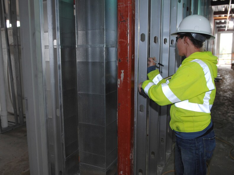 MINOT AIR FORCE BASE, N.D.-- Interior wall panels are measured in the new base dormitories Aug. 12, by contractor Bobbie Gonzalez. The new dormitories are being built to accommodate the base’s influx of new Airmen in support of Global Strike Command. The dorms will be more modern and updated to provide Airmen with a comfortable home. (U.S. Air Force Photo by SSgt Stacy Moless)