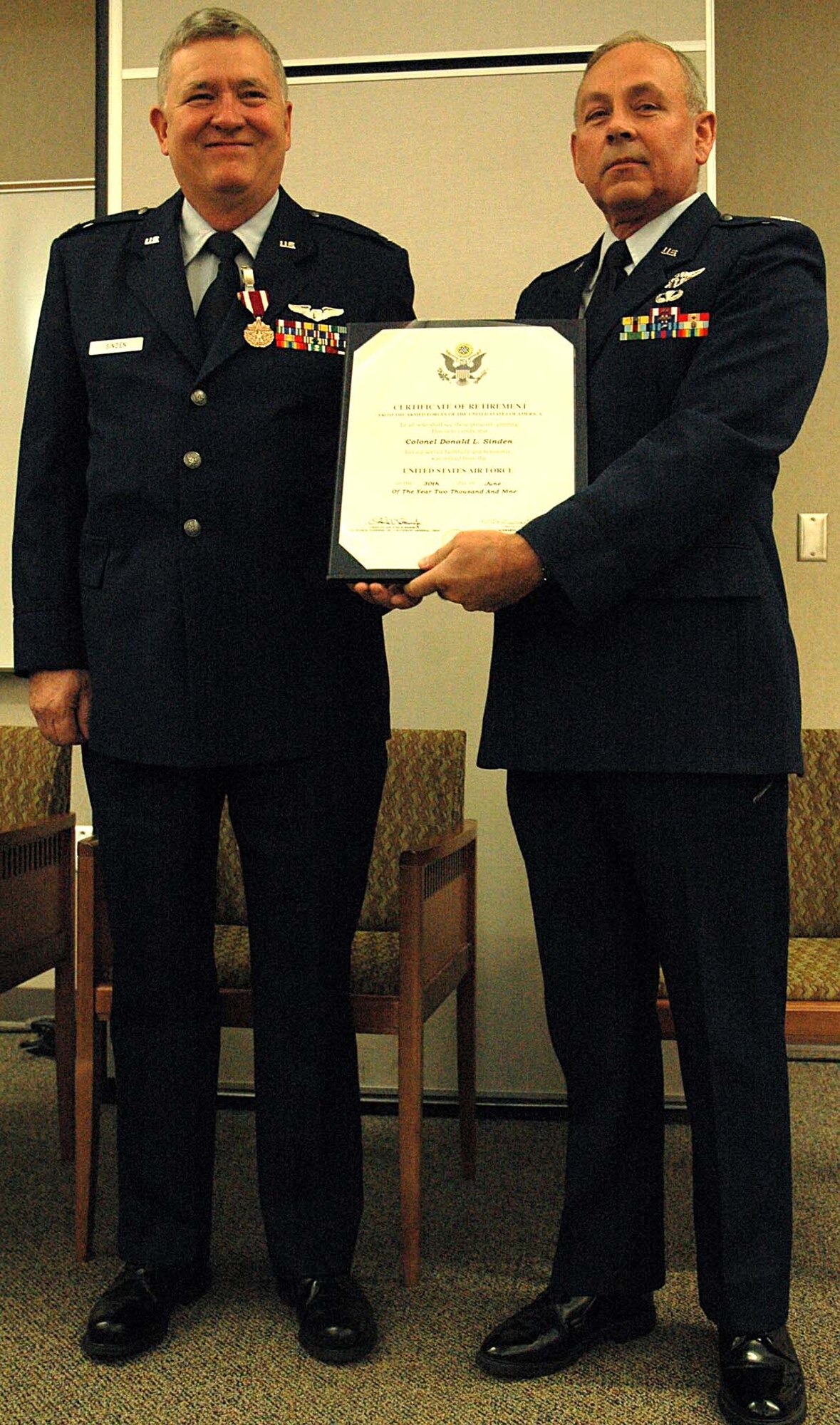 Col. Donald Sinden, left, 446th Aerospace Medicine Squadron, is presented with his certificate of retirement by Col. Michael Jones, 446th Airlift Wing special assistant to the commander.  Colonel Sinden gave 24 years of service to his country and the Air Force.  (Air Force photo/Senior Airman Patrick Cabellon)