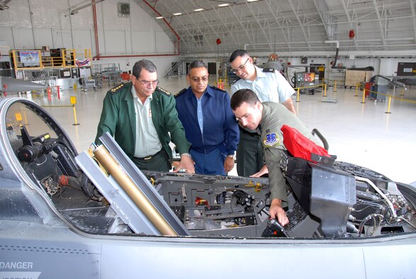Gen. Moises Omar Halleslevens, head of the Nicaraguan military, and Brig. Gen. Jorge Alberto Miranda, chief of the Nicaraguan army air force, observe as Capt. Joseph Walter, 115th Fighter Wing, details the cockpit of an F-16 fighter jet. Capt. Gilberto Ruiz, who served as an escort for the Nicaraguan officers, looks on. The Nicaraguan Chief of Defense staff visited Wisconsin July 22 through 24 as part of the ongoing State Partnership Program between Wisconsin and the Republic of Nicaragua. The military exchange has been in place since 2003. (Photo by Tech. Sgt. Jon LaDue)