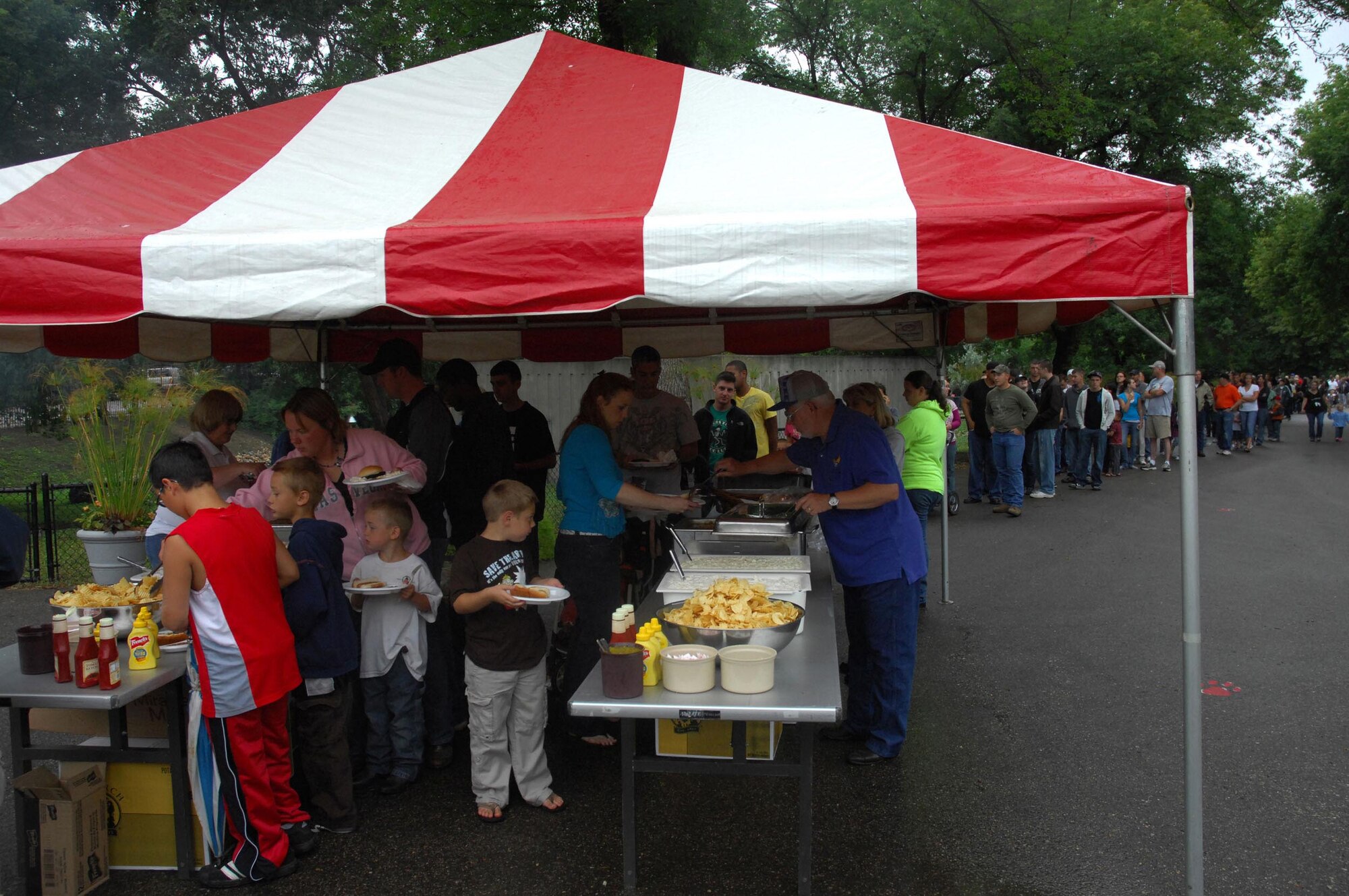 MINOT AIR FORCE BASE, N.D. -- People line up for a free meal during a military appreciation day at the Roosevelt Zoo in Minot Aug.  8. The city of Minot offered free access and a free meal to military individuals and their families. Hundreds of military personnel attended the event.  (U.S Air Force photo by Senior Airman Wesley Wright)