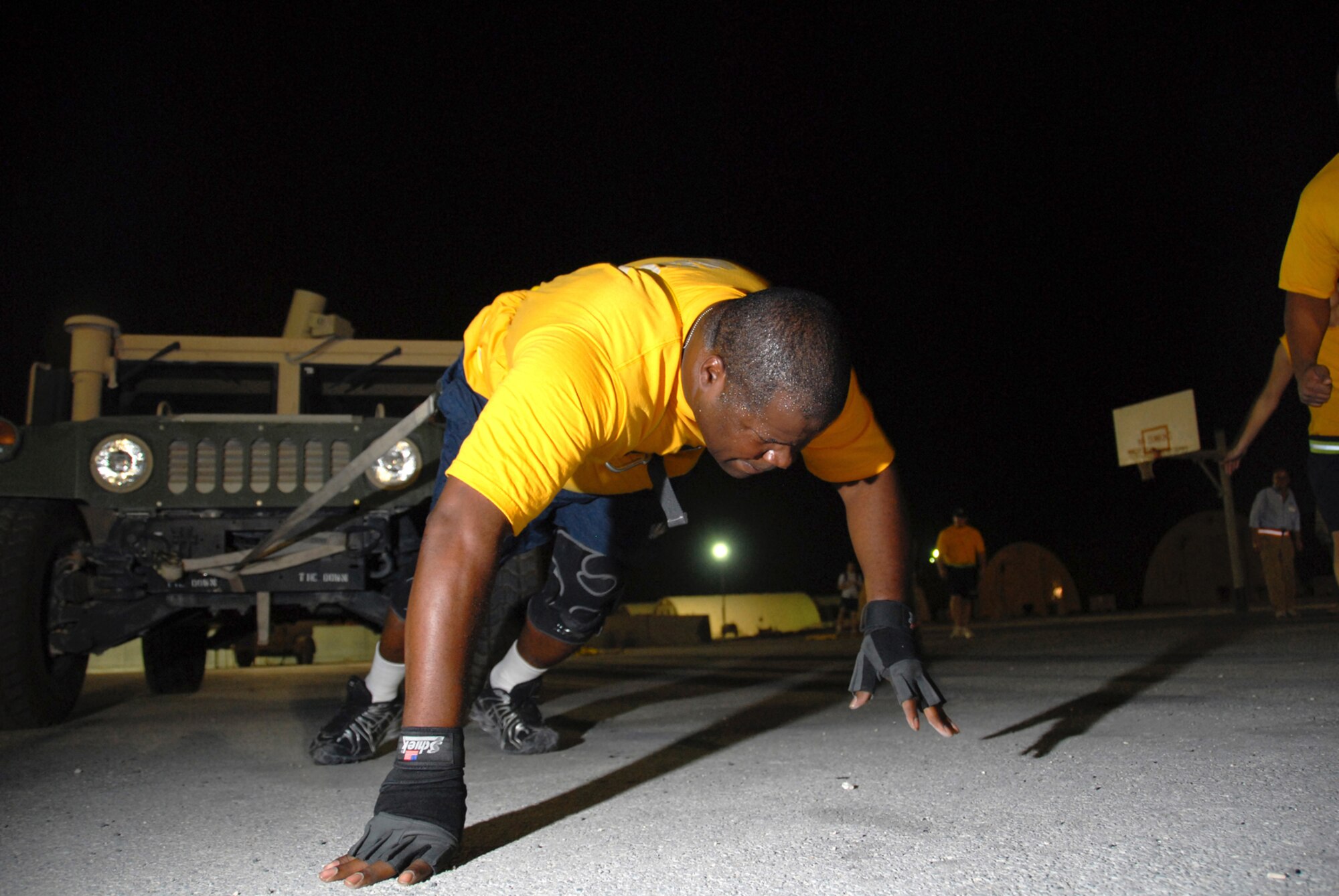 Navy Petty Officer 1st Class Clenzo Kitchen, VP-10, pulls a High Mobility Multipurpose Wheeled Vehicle in the Commander?s Cup Sahara Challenge event, here, Aug. 11. The Commander?s Cup Challenge, open to all military, Department of Defense civilians and contract employees, is a 10-event competition designed to build unit and wing esprit de corps. Petty Officer Kitchen is a native of Houston, Texas and is deployed from Jacksonville Naval Air Station, Fla., in support of Operations Iraqi and Enduring Freedom.   (U.S. Air Force Photo/Tech. Sgt. Jason W. Edwards)