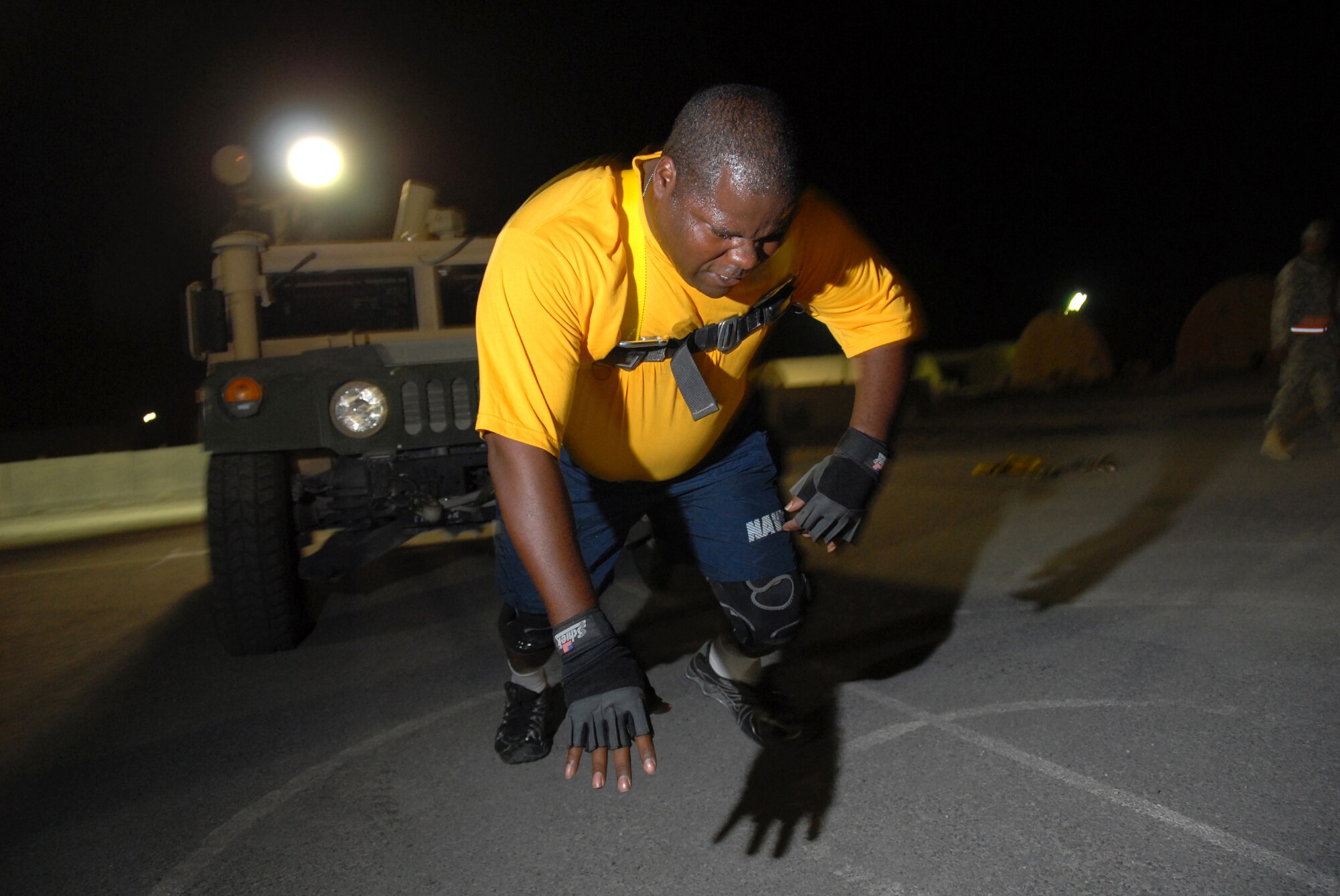 Navy Petty Officer 1st Class Clenzo Kitchen, VP-10, pulls a High Mobility Multipurpose Wheeled Vehicle in the Commander?s Cup Sahara Challenge event, here, Aug. 11. The Commander?s Cup Challenge, open to all military, Department of Defense civilians and contract employees, is a 10-event competition designed to build unit and wing esprit de corps. Petty Officer Kitchen is a native of Houston, Texas and is deployed from Jacksonville Naval Air Station, Fla., in support of Operations Iraqi and Enduring Freedom.   (U.S. Air Force Photo/Tech. Sgt. Jason W. Edwards)